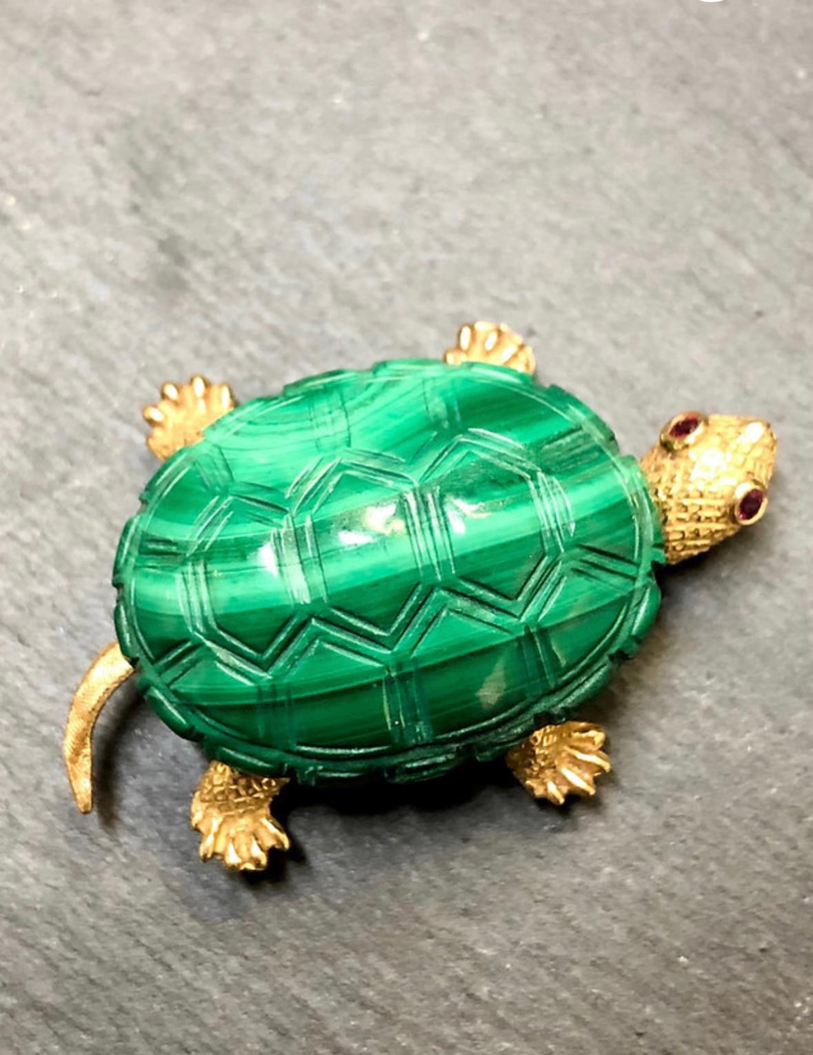 A sweet little turtle pin done in 18K yellow gold with Ruby eyes and an etched malachite shell. Very well done.

Dimensions
1.60” long by 1” wide.

Condition
Very wearable condition. No issues.I’m 