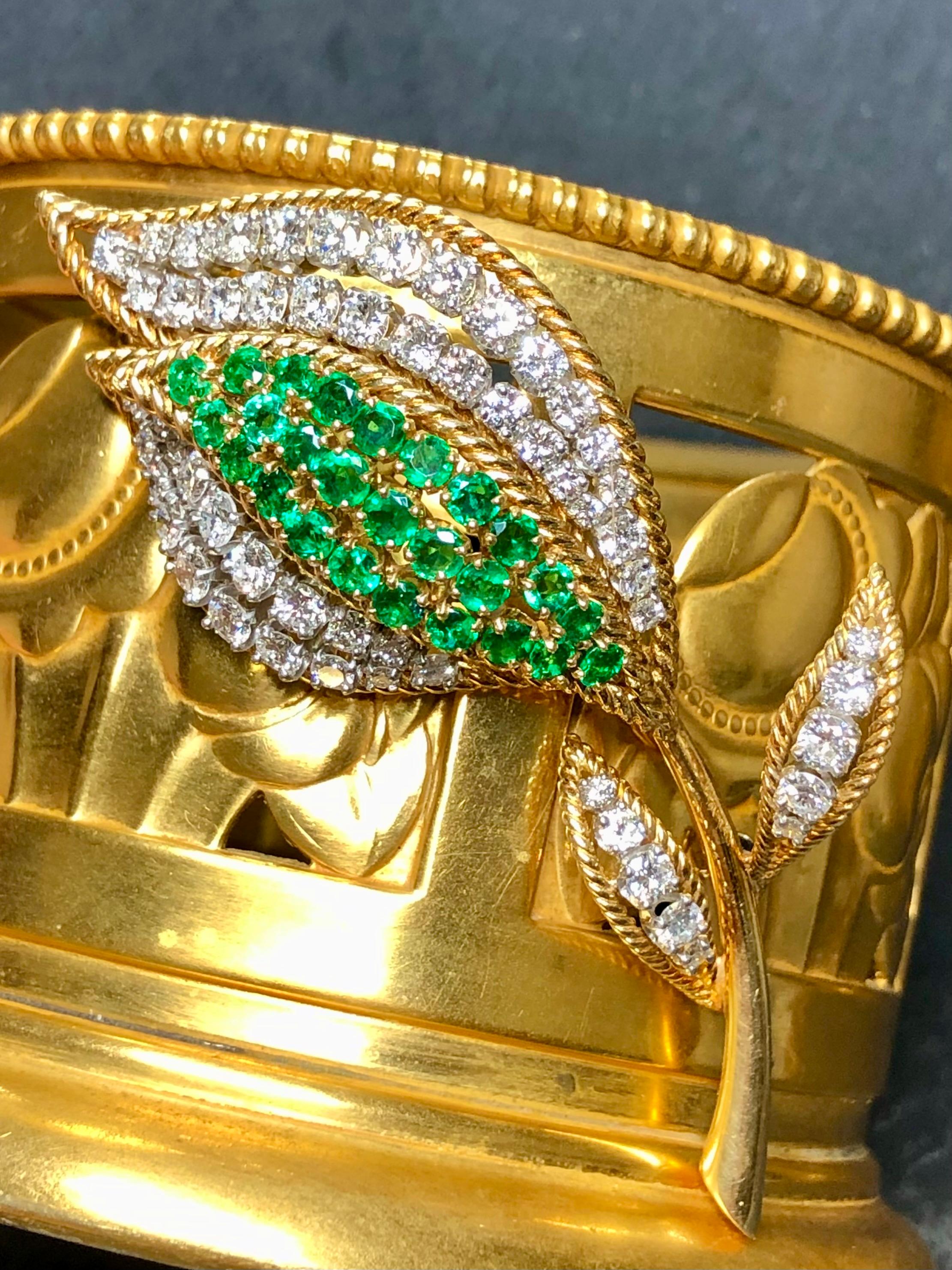 A beautifully made vintage brooch circa the 1960’s done in rich 18K yellow gold and platinum. It has been set with approximately 3.75cttw in G-H Vs clarity round diamonds and finished with vibrantly green natural emeralds.

Dimensions/Weight
2 3/4”