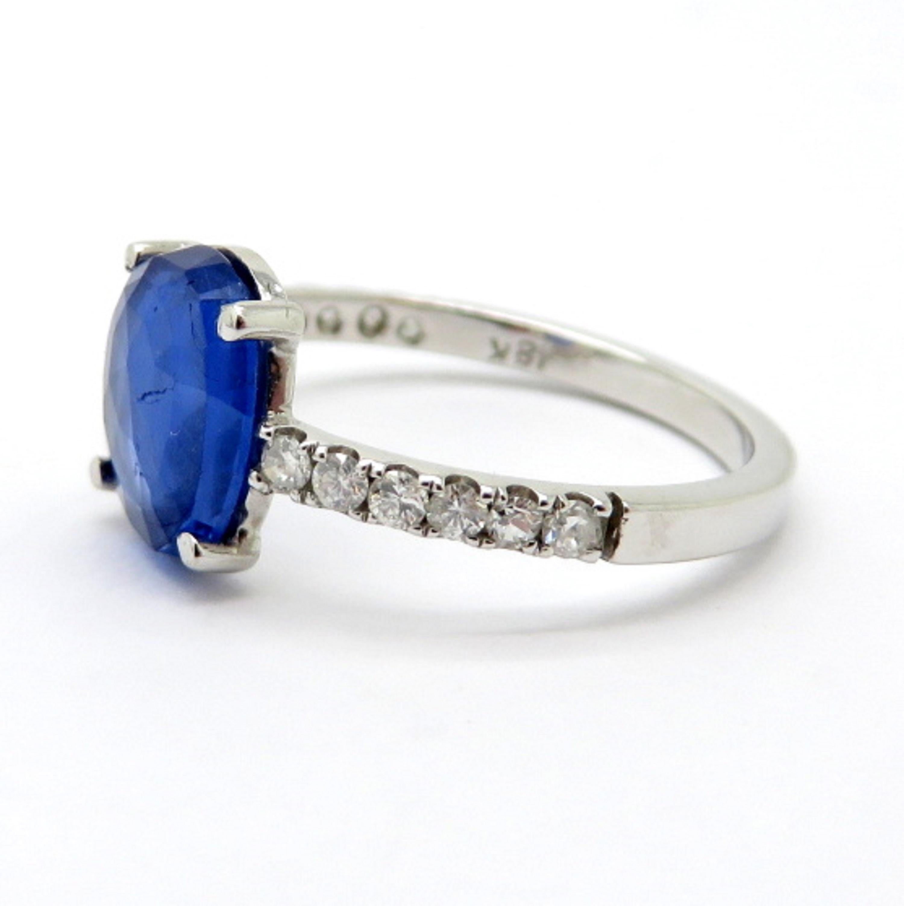 Estate vintage 18K white gold Burmese blue sapphire and diamond ring. Showcasing one GIA certified oval Burmese Sapphire weighing 2.08 carats. The certificate is not available. Please refer to the GIA colored stone grading report # 2185624637.