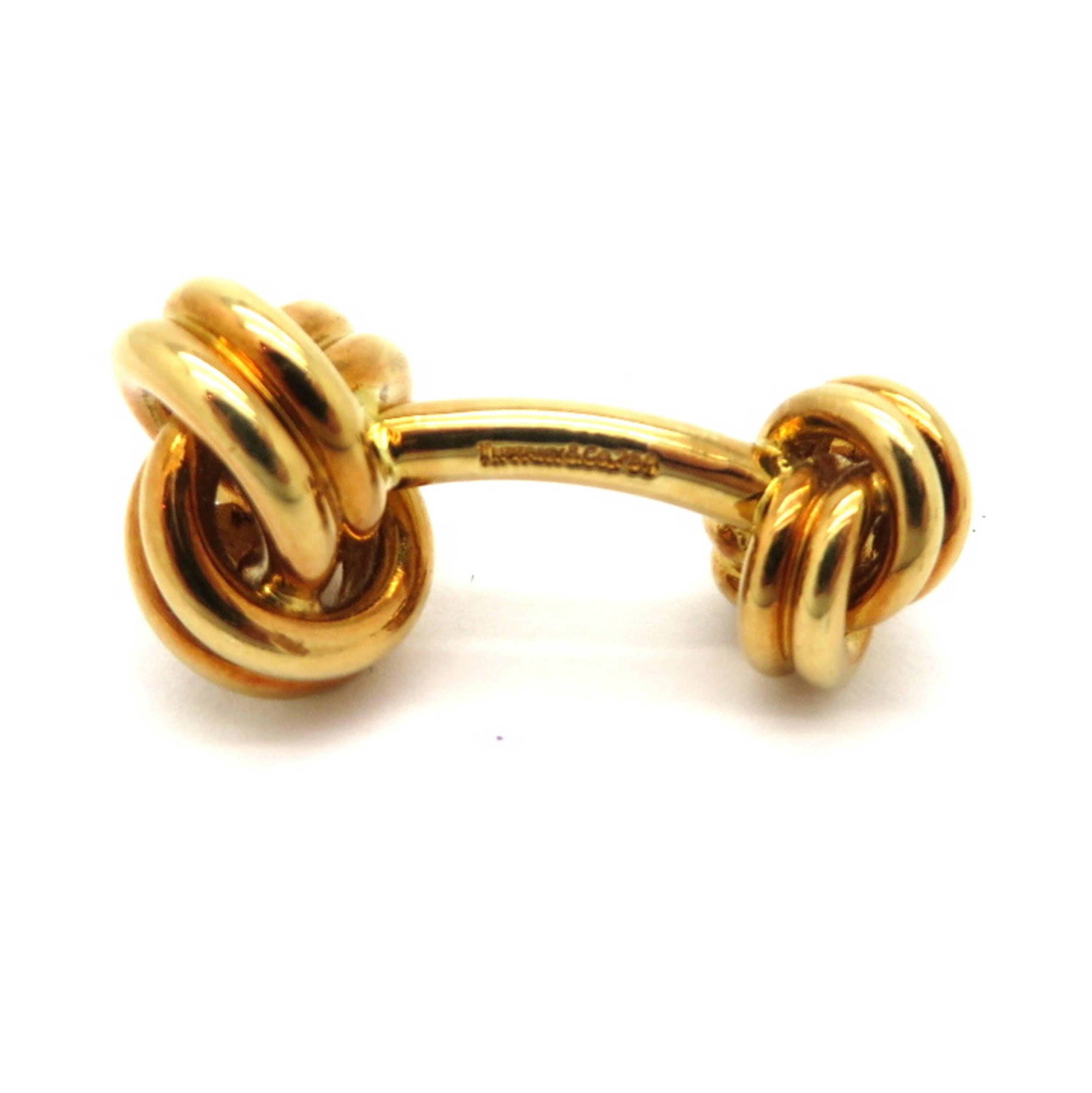 Estate 18K yellow gold Tiffany & Co. love knot cufflinks. The designer Tiffany & Co. cufflinks are hallmarked Tiffany & Co. 750. They are each crafted out of 18K solid yellow gold and have a high polish finish. The Tiffany & Co. box is included.
