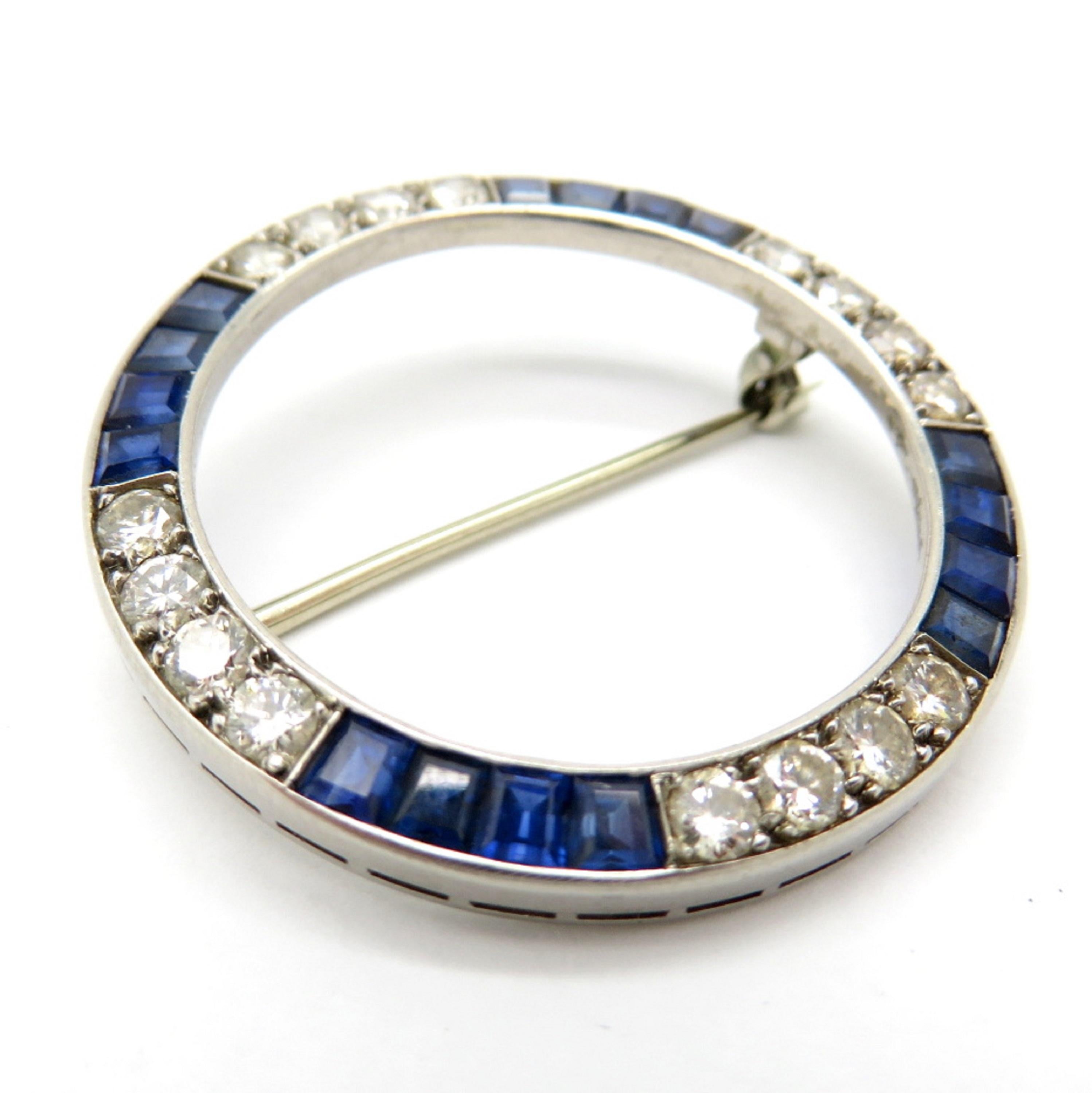 For sale is a classic Estate Diamond & Sapphire Circular Pin!
Featuring sixteen (16) Round Brilliant Cut diamonds, measuring 2.75 mm each average, weighing a total of 1.00 carats. 
Diamond Grading: Color Grade: H-I. Clarity Grade: SI1.
Showcasing