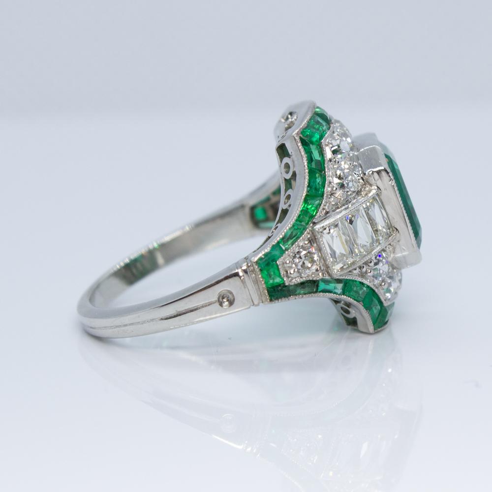 For sale is a lovely Columbian Emerald & Diamond Art Deco Ring!
It is crafted out of Platinum.
Showcasing one (1) Emerald Cut natural Emerald in the center weighing approximately 2.85 carats. 
Accenting the emerald are six (6) French Cut diamonds,