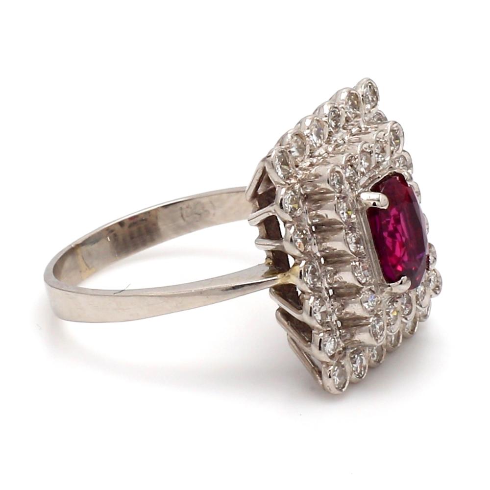 Platinum cocktail ring.  Center stone is one (1) oval cut ruby weighing 1.05ct. Ruby is surrounded by forty (40) round brilliant cut diamonds weighing approximately 1.00ctw. Ring weighs 6.5 grams and is a size 6.25. 
All questions answered.
All