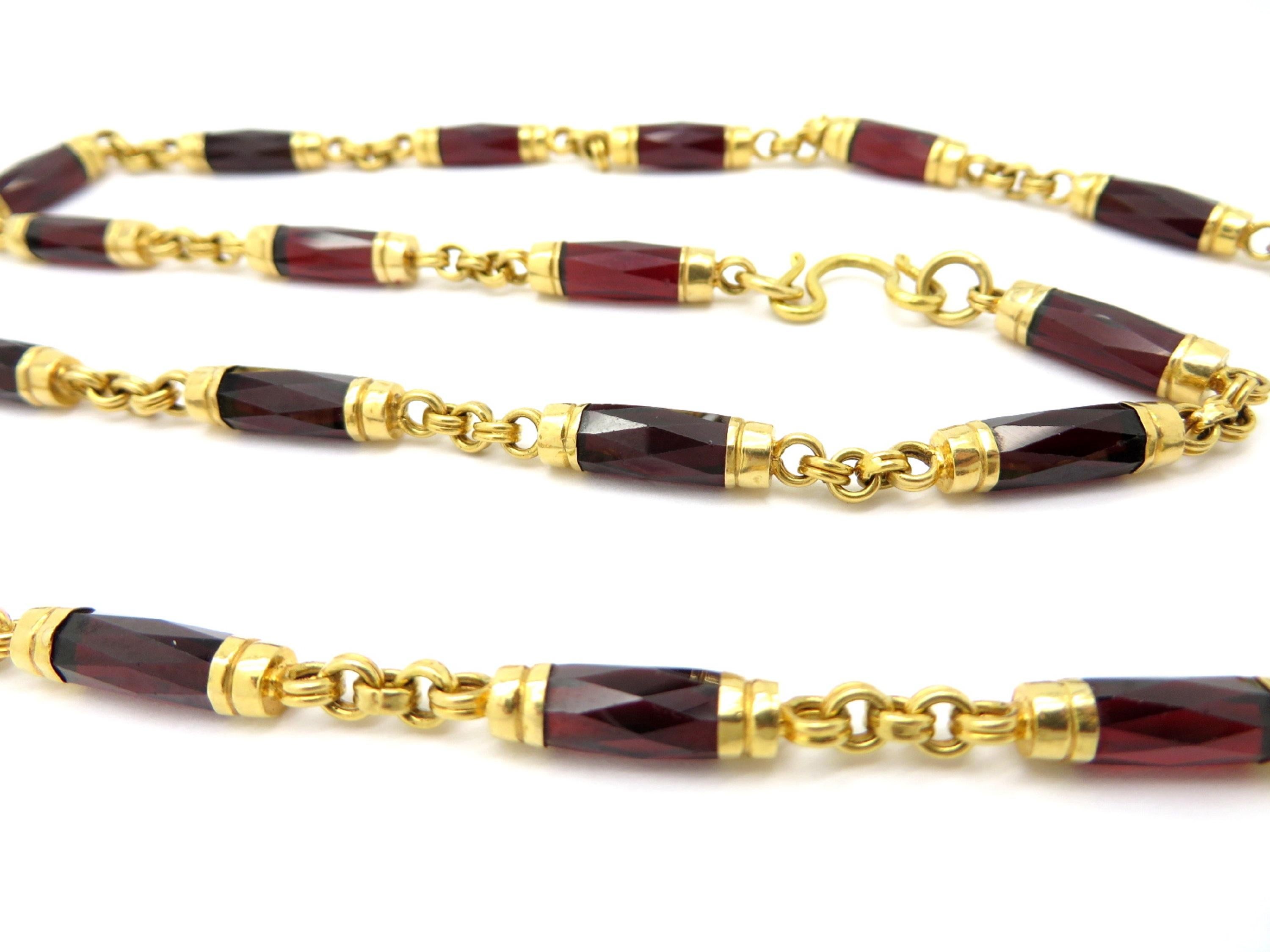For sale is a lovely estate 20K Yellow Gold Garnet necklace with gold spiral connecting links!
Showcasing 29 faceted barrel shaped Garnet gemstones, weighing a combined total of 115.00 carats.
Each barrel measures 6.00 mm average.  
The length of