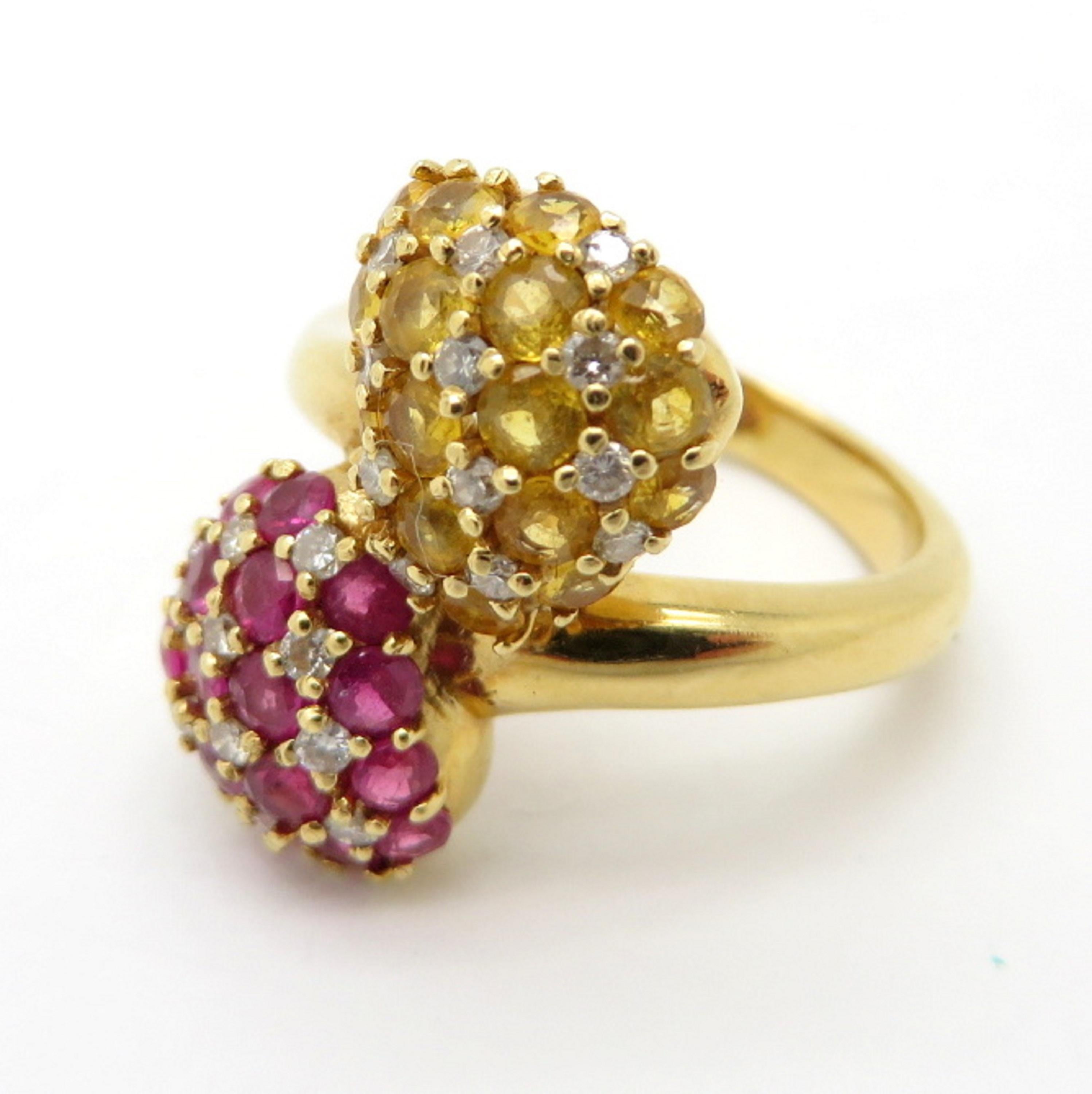 For sale is a lovely estate pave yellow sapphire and ruby bypass ring set in 18K Yellow Gold!
Featuring 34 Round Brilliant Cut yellow sapphires and rubies, with various measurements and 24 Round Brilliant Cut diamonds, weighing 0.15 carats.  
The