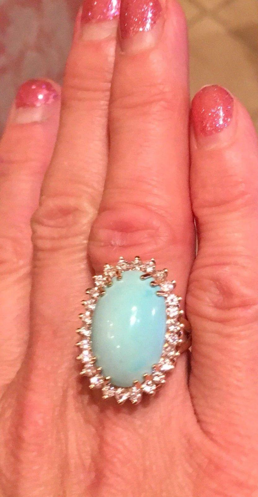 Gorgeous vibrant 14K yellow gold cocktail ring featuring an oval turquoise cabochon and 24 white colorless round brilliant diamonds with VS-SI1 clarity, totaling approximately 1.08 carats.

The ring is marked 14k gold on the inside shank.

The