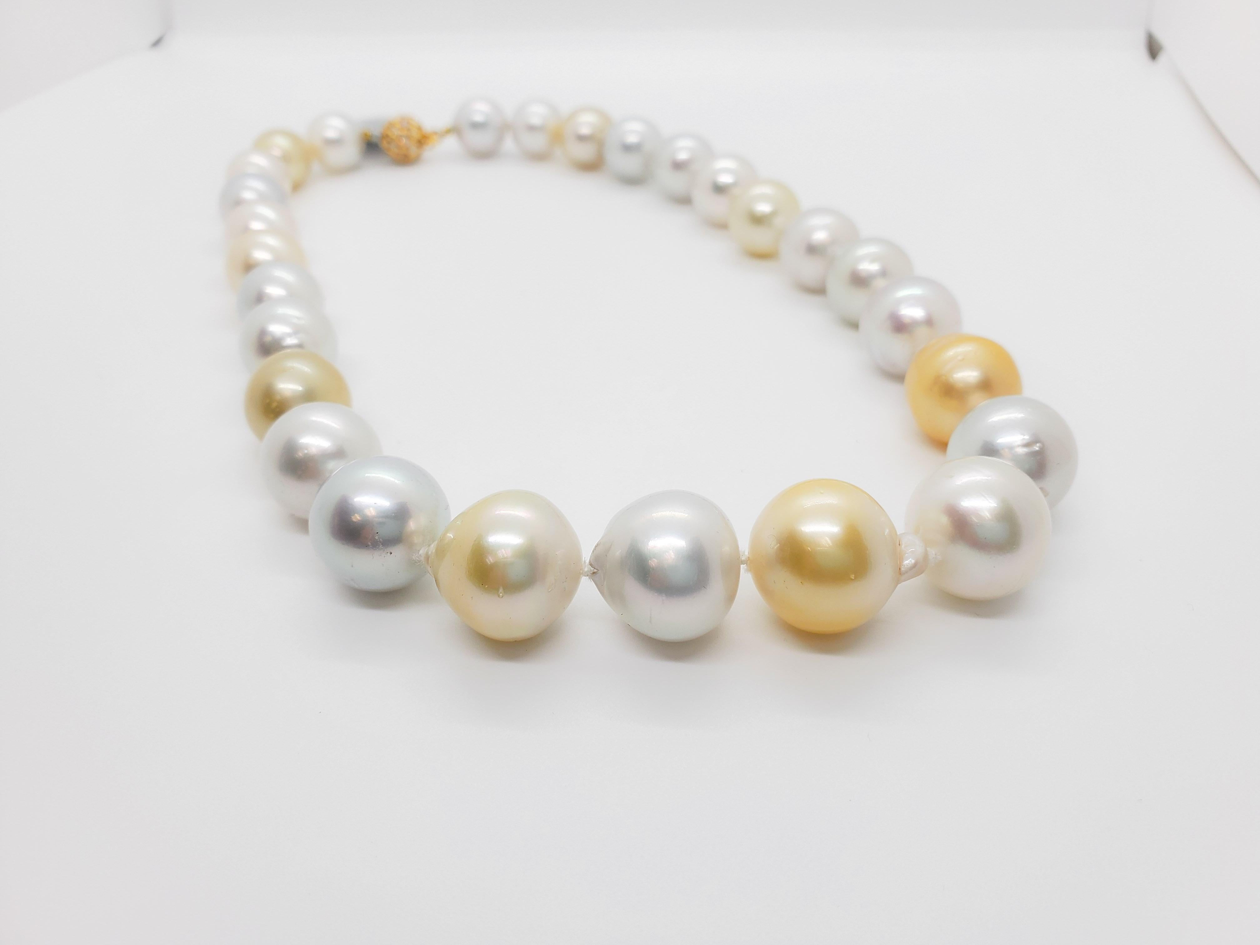Beautiful necklace showcasing 27 white and yellow South Sea pearls and 0.50 ct. of white diamond rounds in a 18k yellow gold clasp.  Superb luster and minimal to no blemishes. The alternating white and yellow pearls make this classic necklace unique