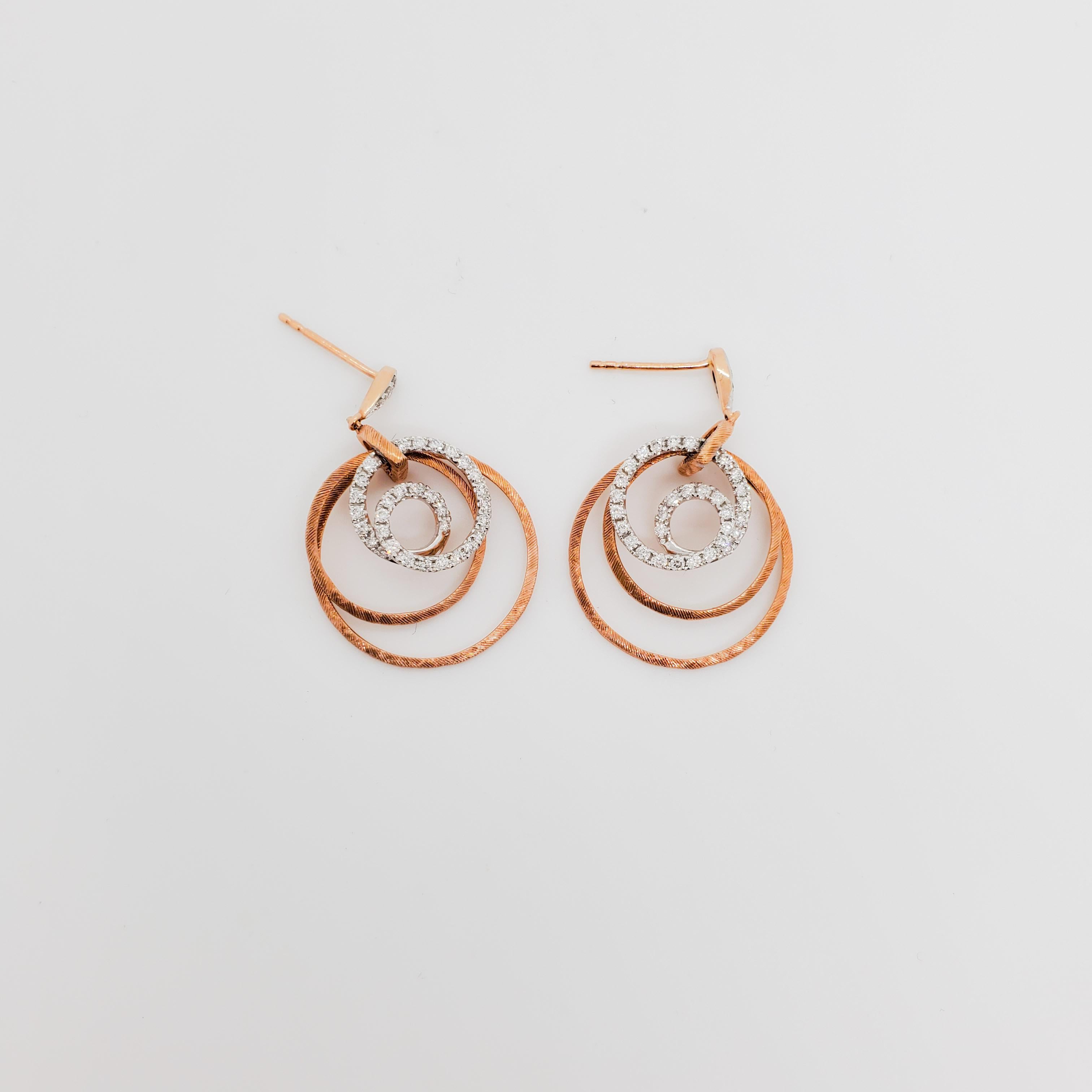 Gorgeous earrings with 0.67 ct. good quality, white, and bright diamond rounds.  Circular design in handmade 14k white and rose gold.  Satin and polish finish.