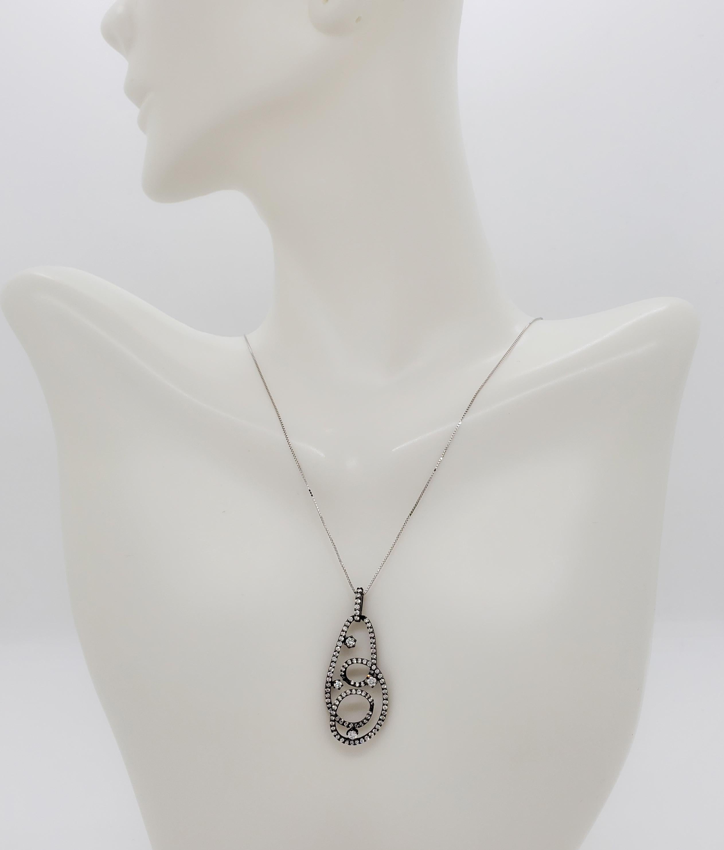 Beautiful pendant with 0.64 ct. good quality, white, and bright diamond rounds.  Handmade in 14k white gold and black rhodium.  Chain is 18