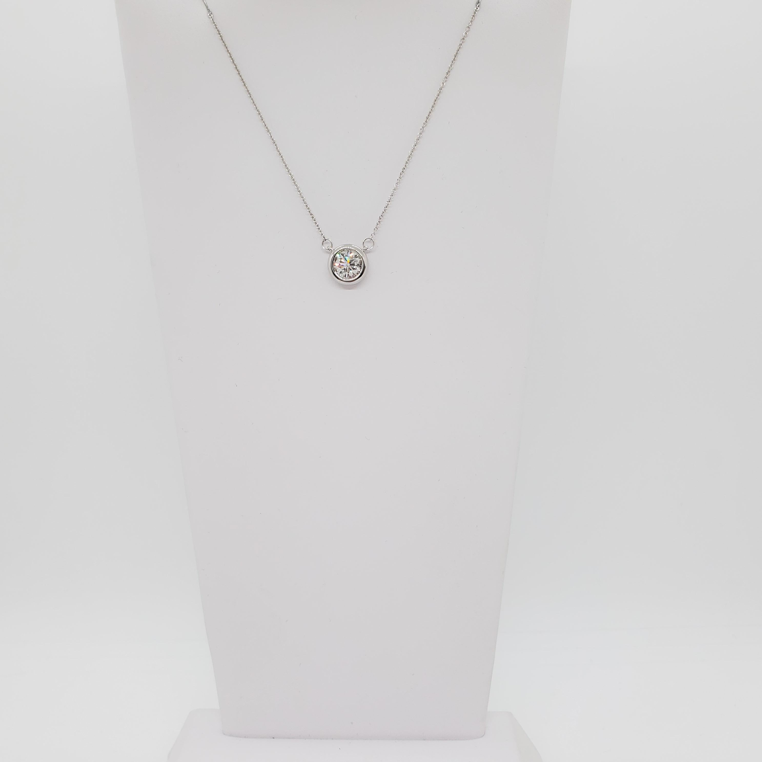 Beautiful and simple white diamond round in a bezel setting.  Diamond weighs 1.10 ct. and is a very nice quality.  Handmade 14k white gold mounting.  Chain length is 18