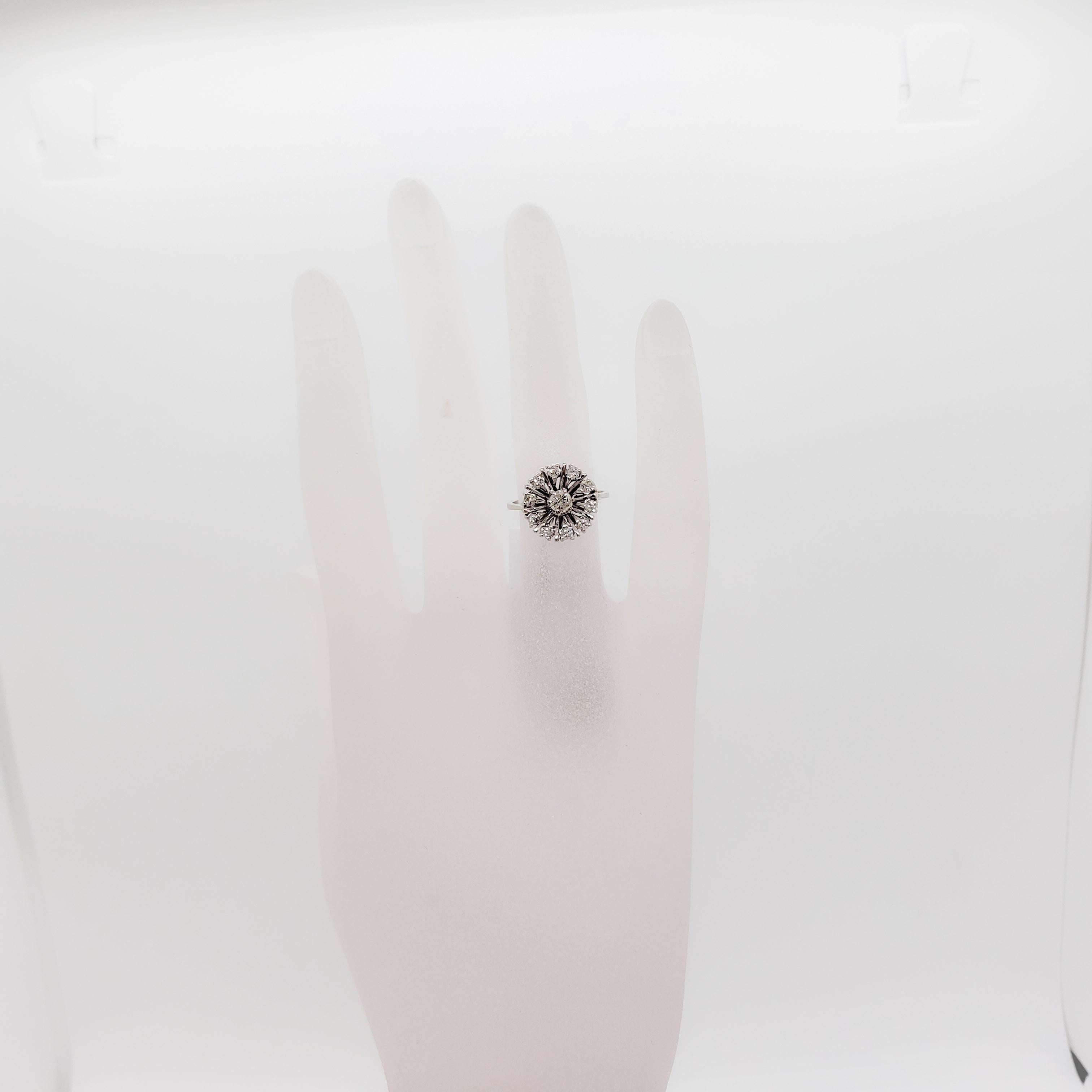 Beautiful flower design ring with good quality white diamond rounds in a handmade 14k white gold mounting.  Ring size 5.25.  Excellent condition.