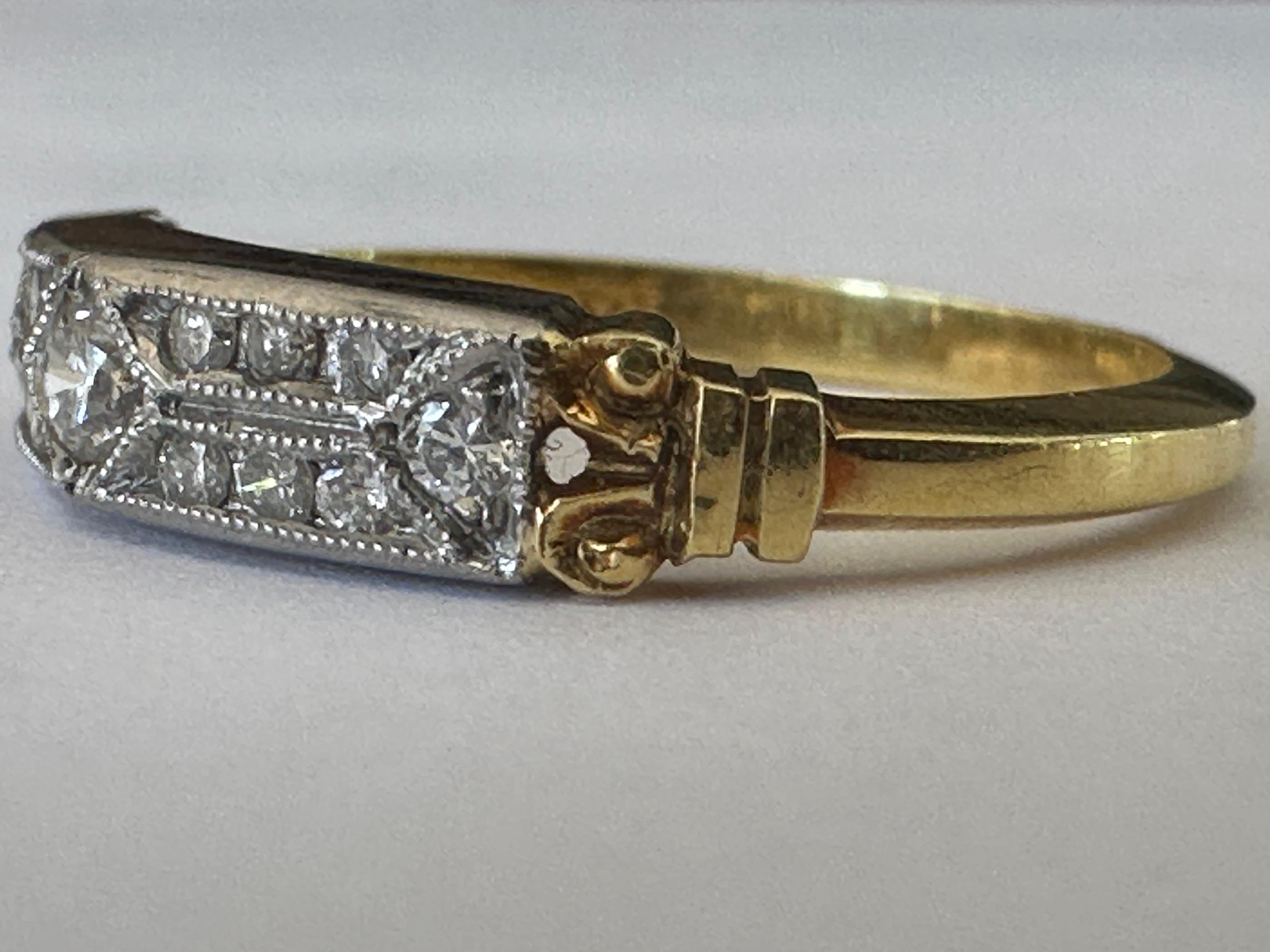 This stunning Estate wedding ring from Whitehouse Brothers in Cincinnati, Ohio is designed around fifteen round diamonds totaling 0.26 carats, EF color, VS clarity, complemented with delicate milgraining. Set in platinum and 18K yellow gold. Stamped