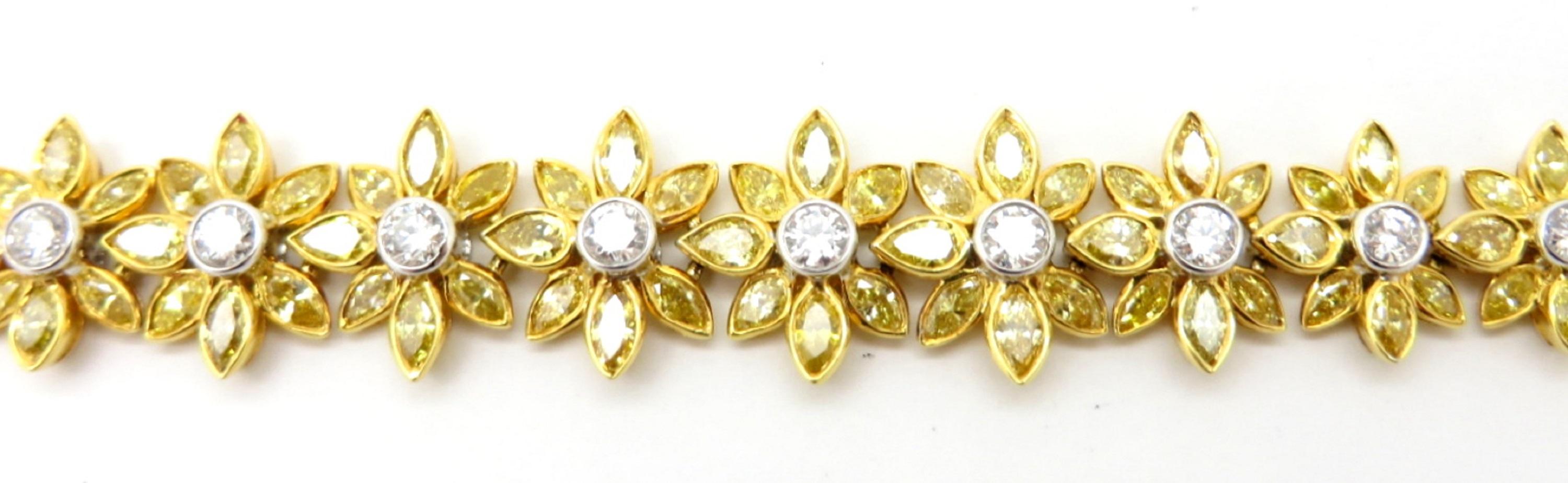For sale is a gorgeous white and yellow diamond flower link tennis bracelet!
Crafted out of solid 18K White and Yellow Gold with a high polish finish.
Showcasing 140 Fancy Vivid Yellow Marquise Brilliant Cut diamonds, each bezel set in yellow gold