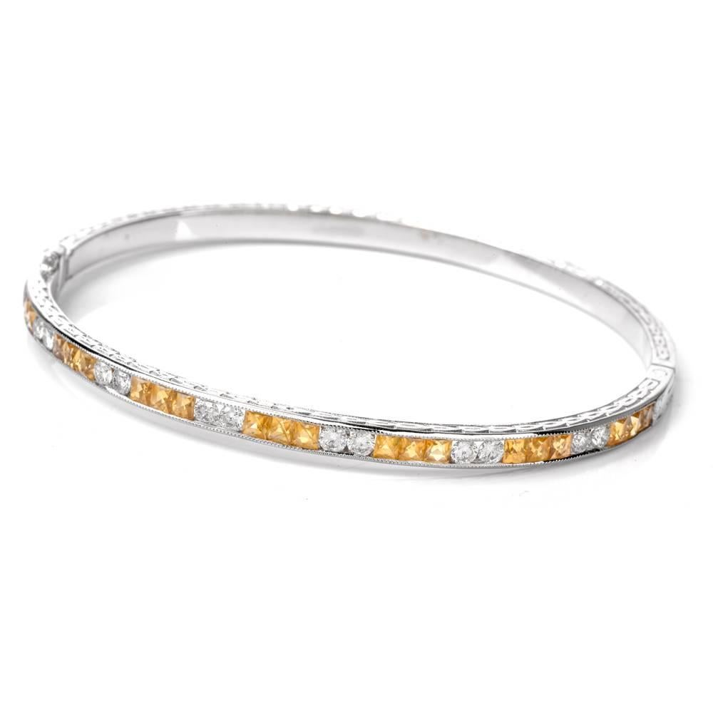 This feminine Art Deco Design bangle bracelet is beautifully crafted in solid 18K white gold, weighing 16.1 grams and measuring 7.0 inches around the wrist. The enchanting bracelet is enriched with 21 channel-set square-cut genuine yellow sapphire,