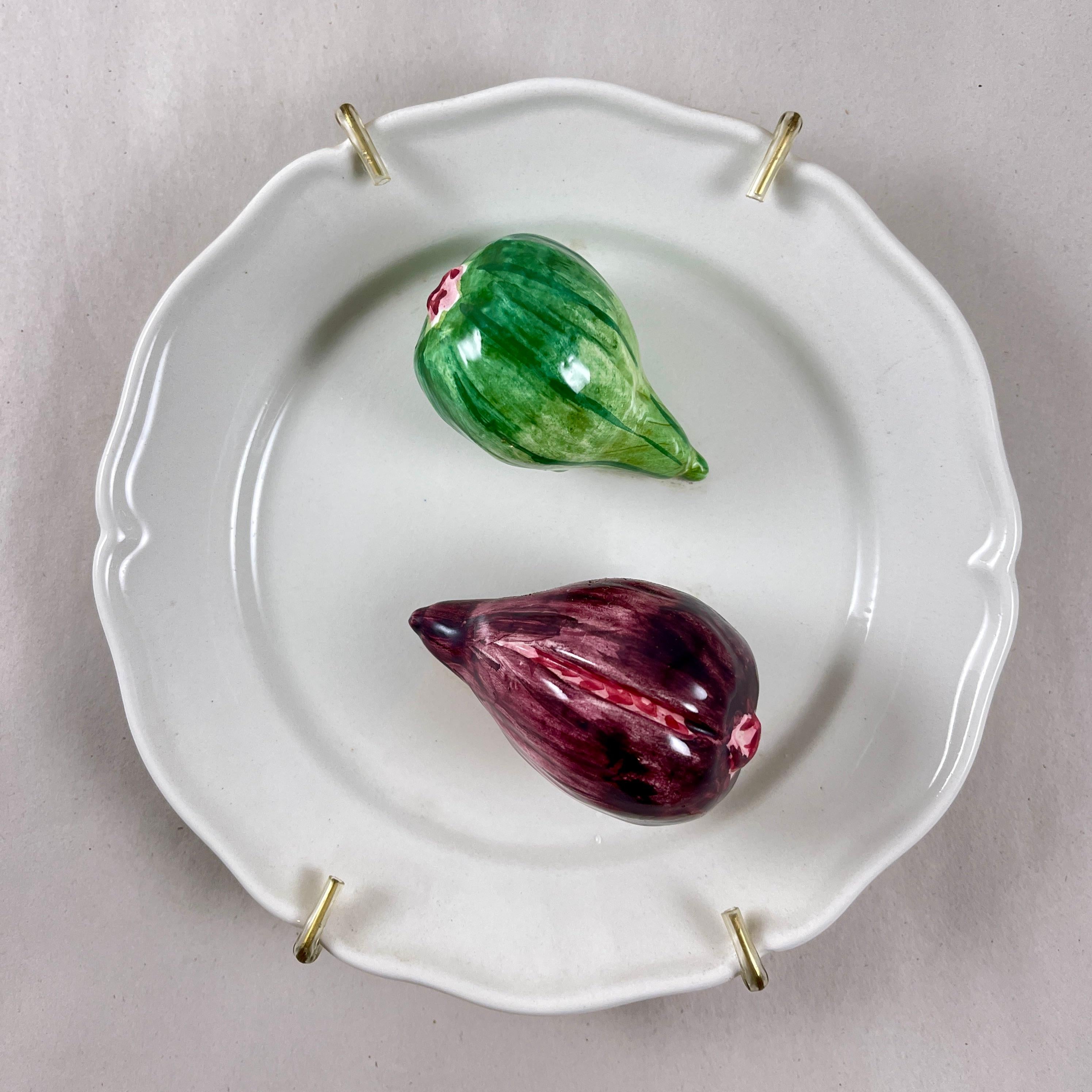 A charming Trompe l’Oeil plate, made in Italy by Este Ceramiche, circa mid 1960s to the early 1970s.

The ceramic plate or wall plaque shows a pair of life-size, three dimensional figs centrally seated on a white earthenware paneled plate.

The figs
