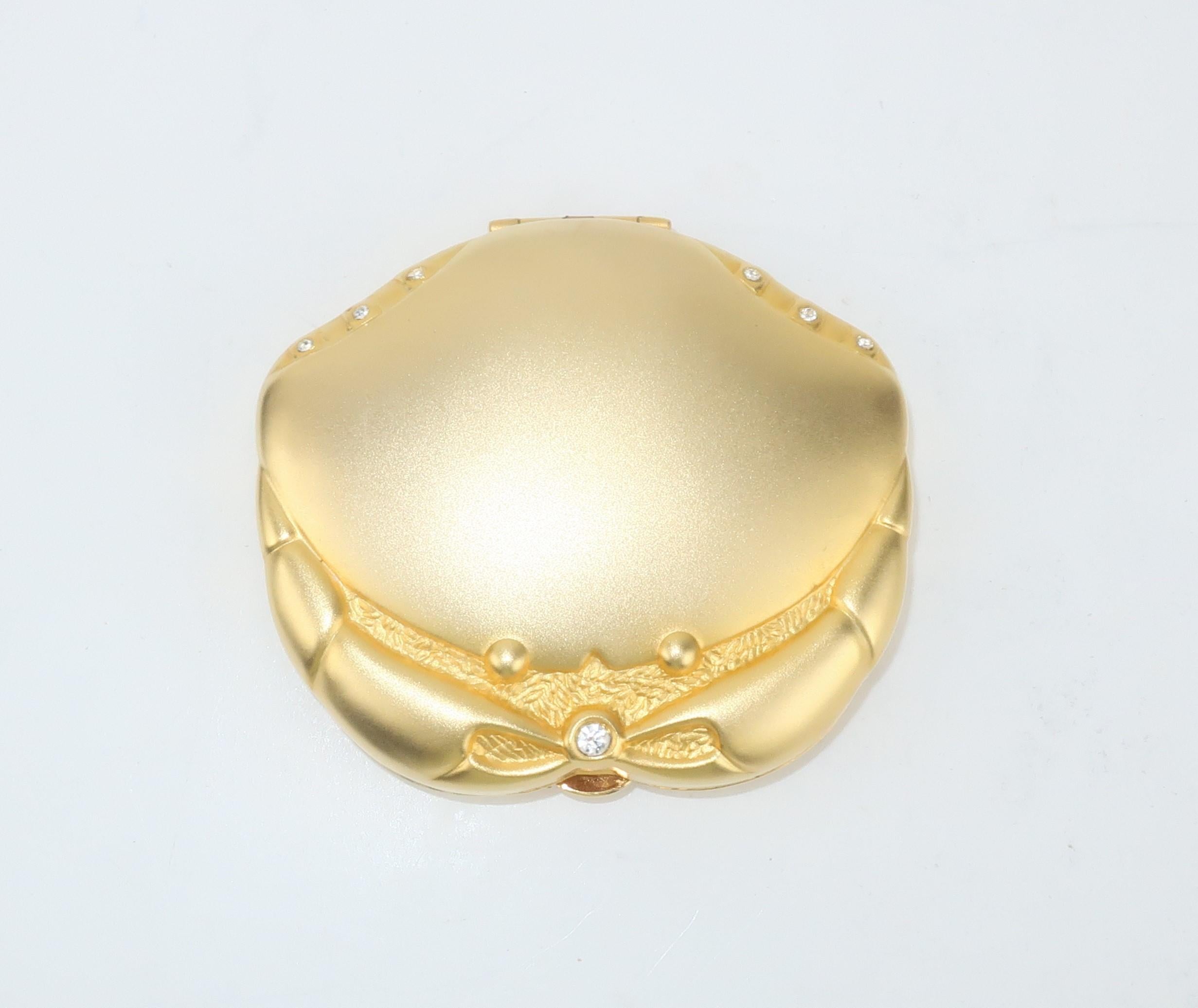 Estee Lauder's Golden Cancer gilt satin finished mirrored powder Zodiac compact accented by crystal rhinestones.  The push button closure opens to reveal mirror and pressed powder with puff.  Estee Lauder has been producing limited edition compacts