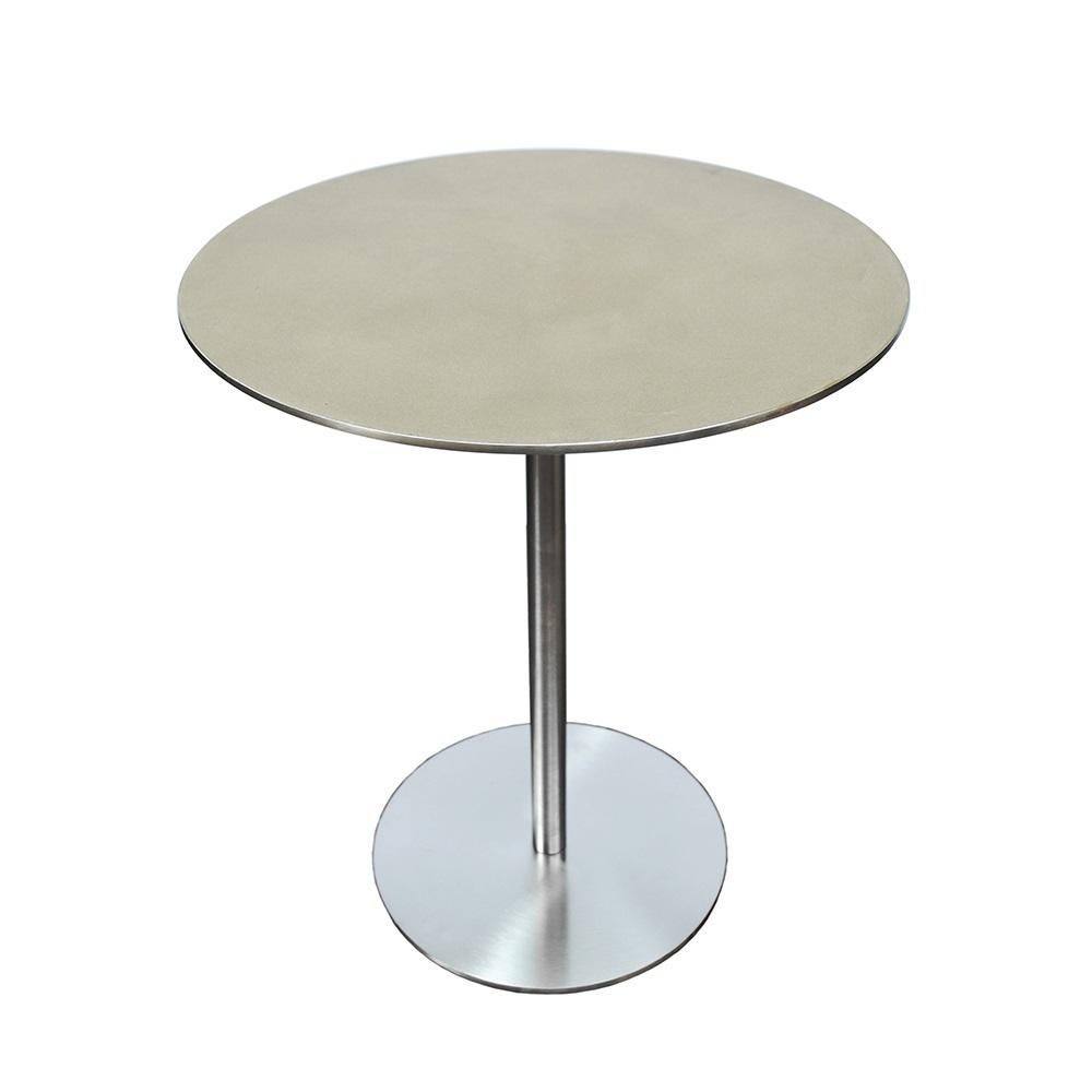 This side table can be used by a sofa or as an accent table, or paired with others from the same series that come in different heights. The base and structure are in stainless steel (either brushed or polished), and the top is coated with clay whose