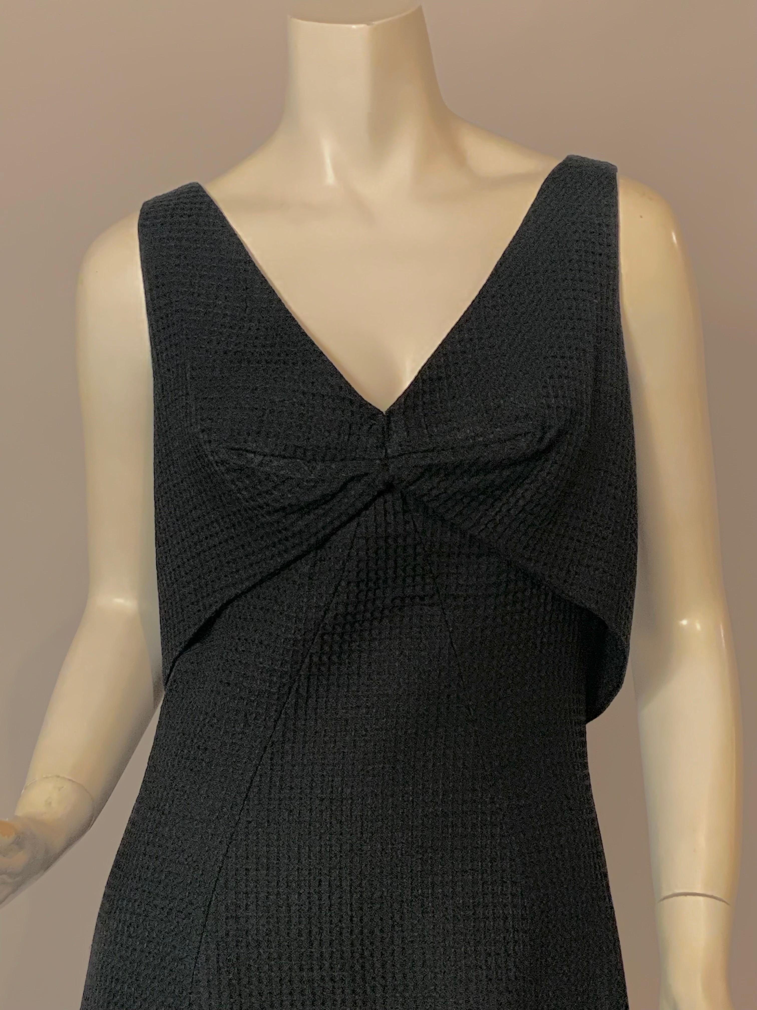 Above all Estevez has designed a perfect jewelry dress with this chic black cotton pique dress with a faux vest.
A great necklace or a brooch would look spectacular set off by the lines and color of this dress.  It has an attached vest at the center