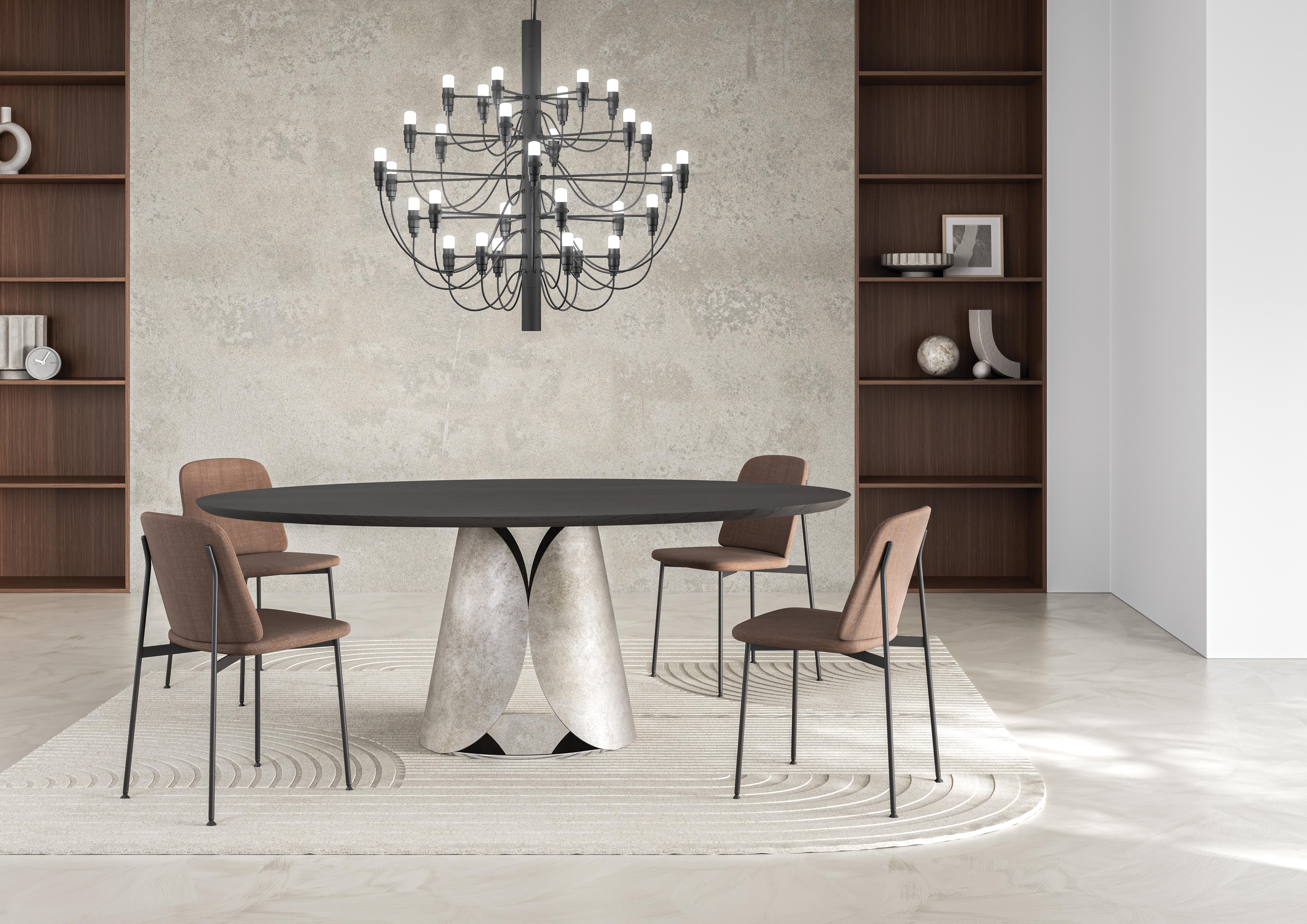 Estia Dining Table by Chinellato Design
Dimensions: D 110 x W 200 x H 71 cm
Materials:
Top:  Thermally Treated Oak.
Base: Black Patinated Silver Leaf finish.

In this table, graceful curves take center stage, exuding an enveloping softness that