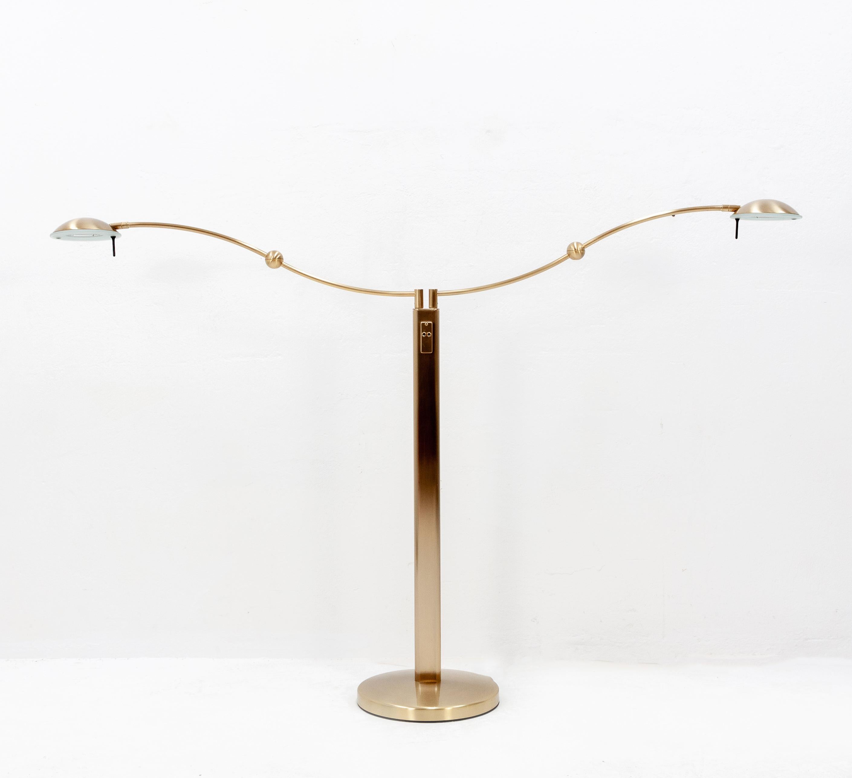 Beautiful dual-arm halogen floor lamp. Individually height adjustable and finished in a satin rose gold. Two position switch. Very good condition, 1980s.
