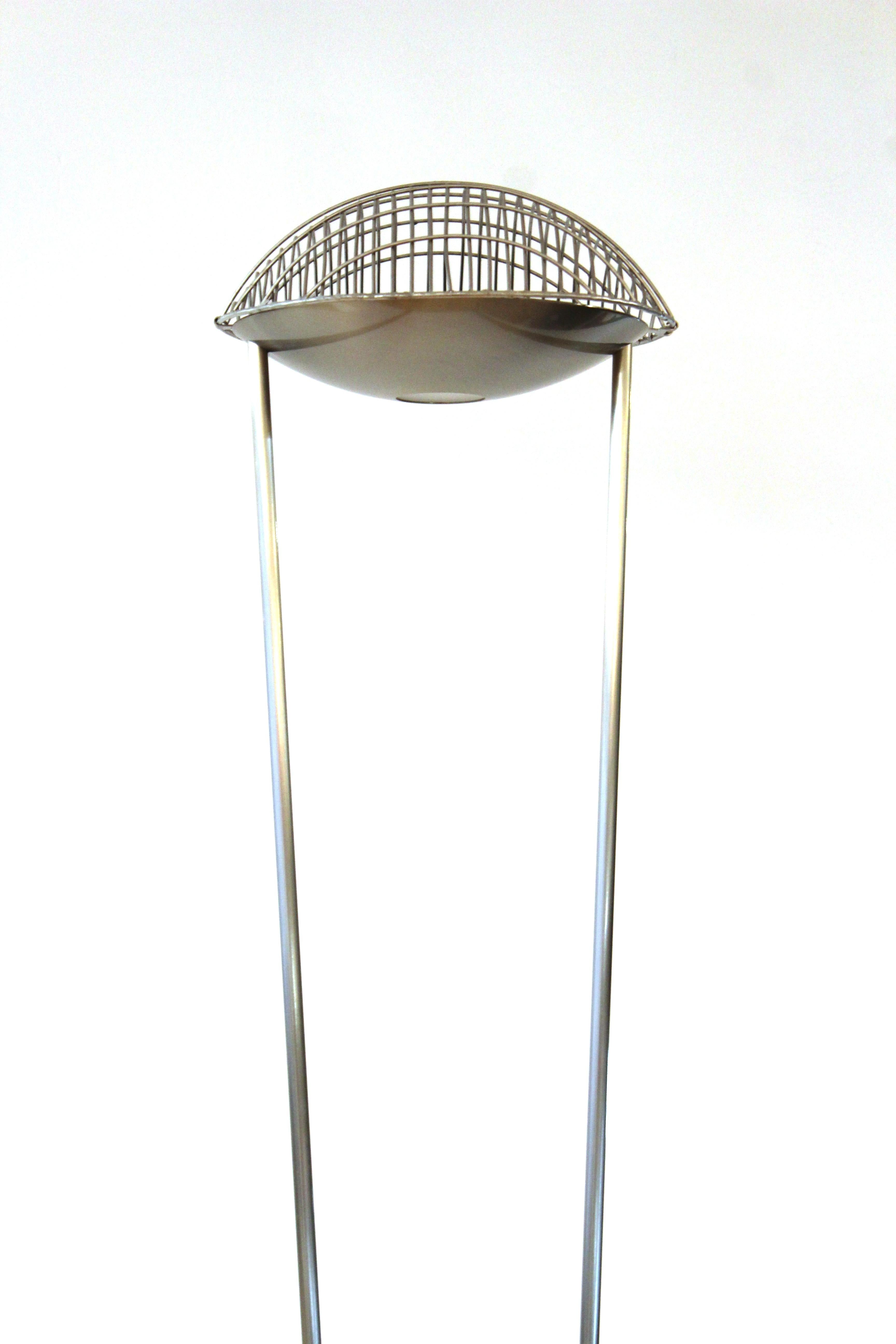 Spanish modern floor light designed by Estiluz. The piece has a double metal stem with a stabilizer and a grille on top of the light. Estiluz mark on top near the light. In great vintage condition with age-appropriate wear and use.