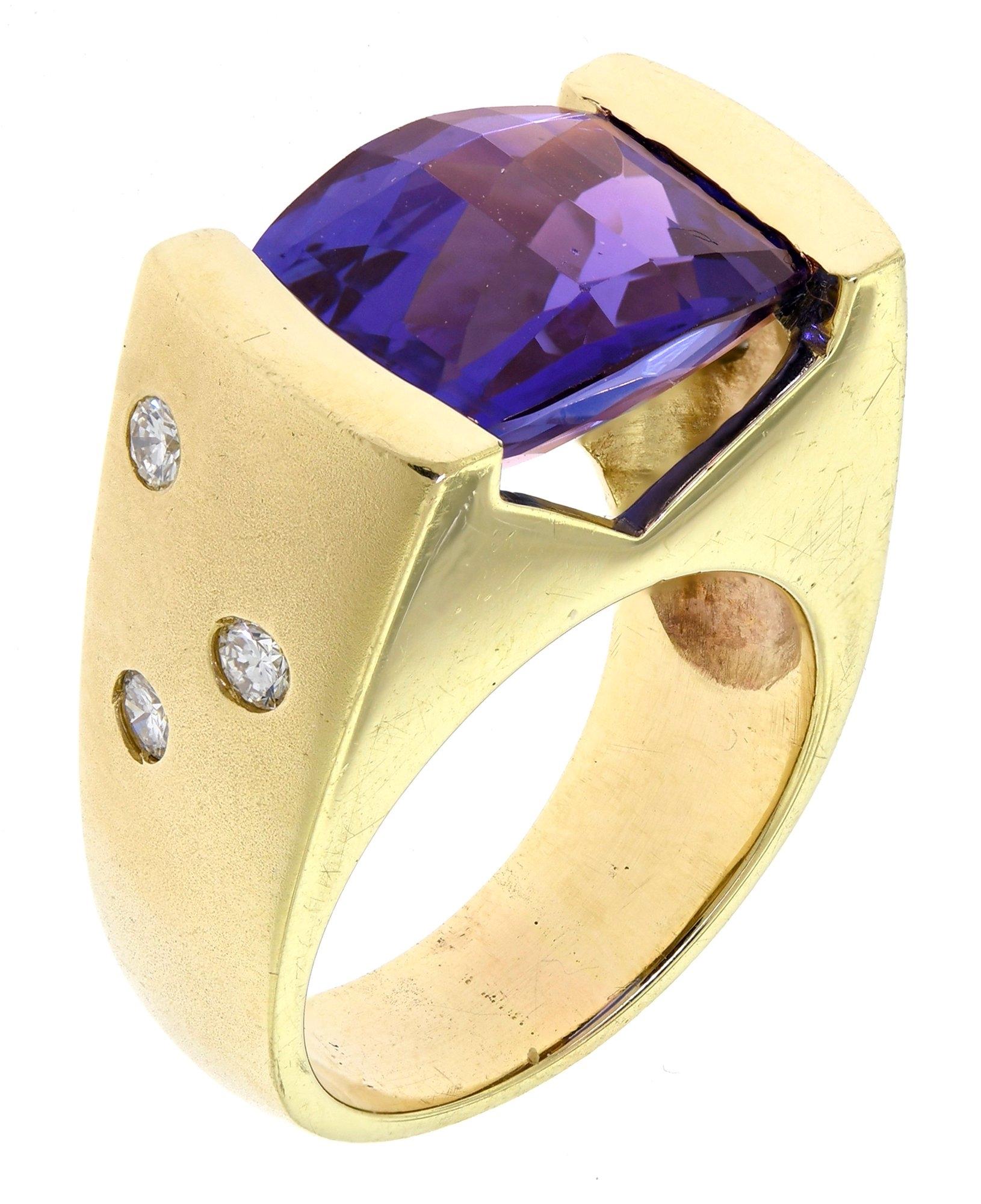 An Estate Piece with a large estimated 9ct Checkerboard Tanzanite in a 16gram 14kt yellow gold ring (that is over 1/2 a troy ounce), brushed gold on the sides, highly polished elsewhere, with 6 diamonds weighing an approximate total of 42pts