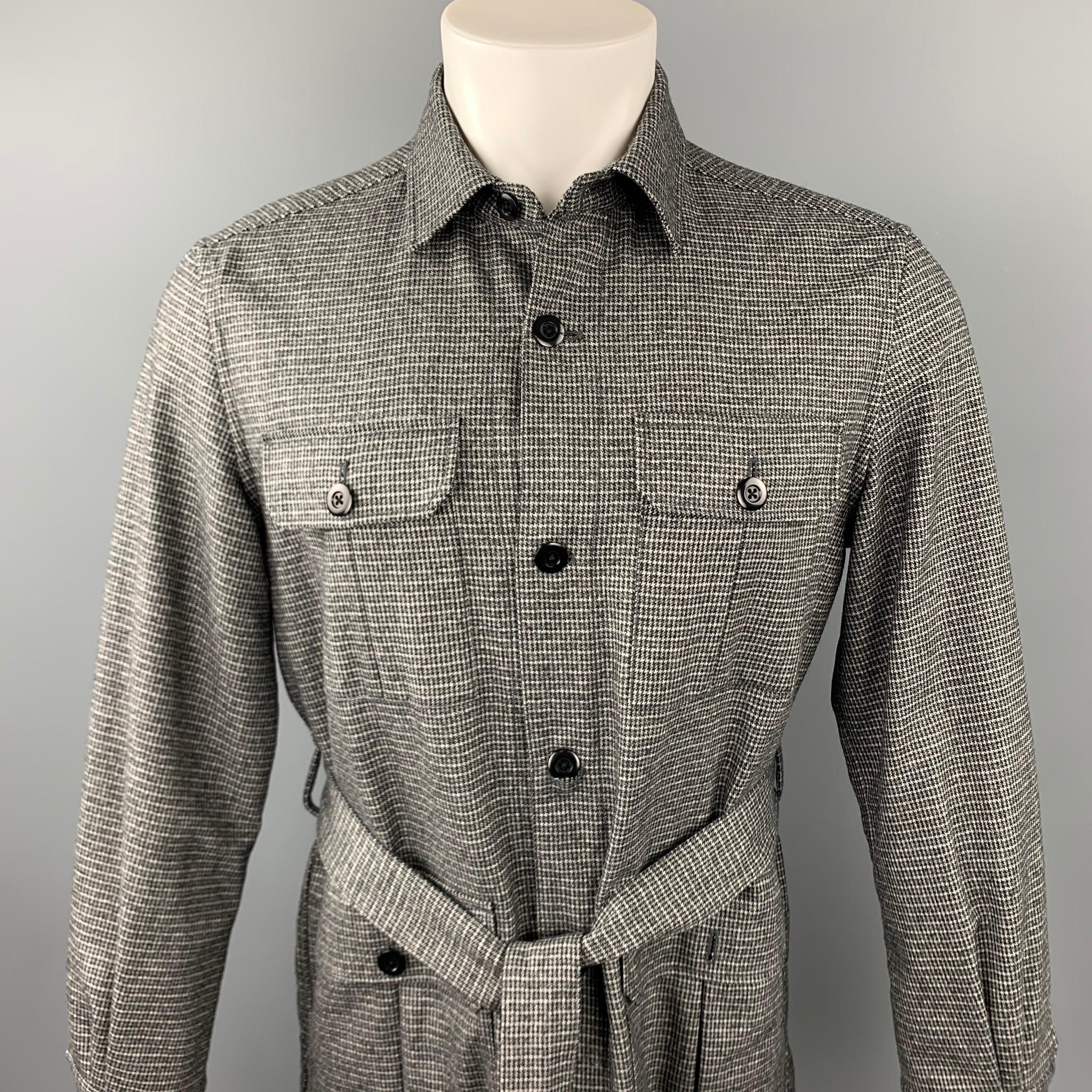 ESTNATION jacket comes in a grey houndstooth wool blend featuring a belted style, front patch pockets, spread collar, and a buttoned closure. 

Excellent Pre-Owned Condition.
Marked: M

Measurements:

Shoulder: 18 in. 
Chest: 40 in. 
Sleeve: 24.5