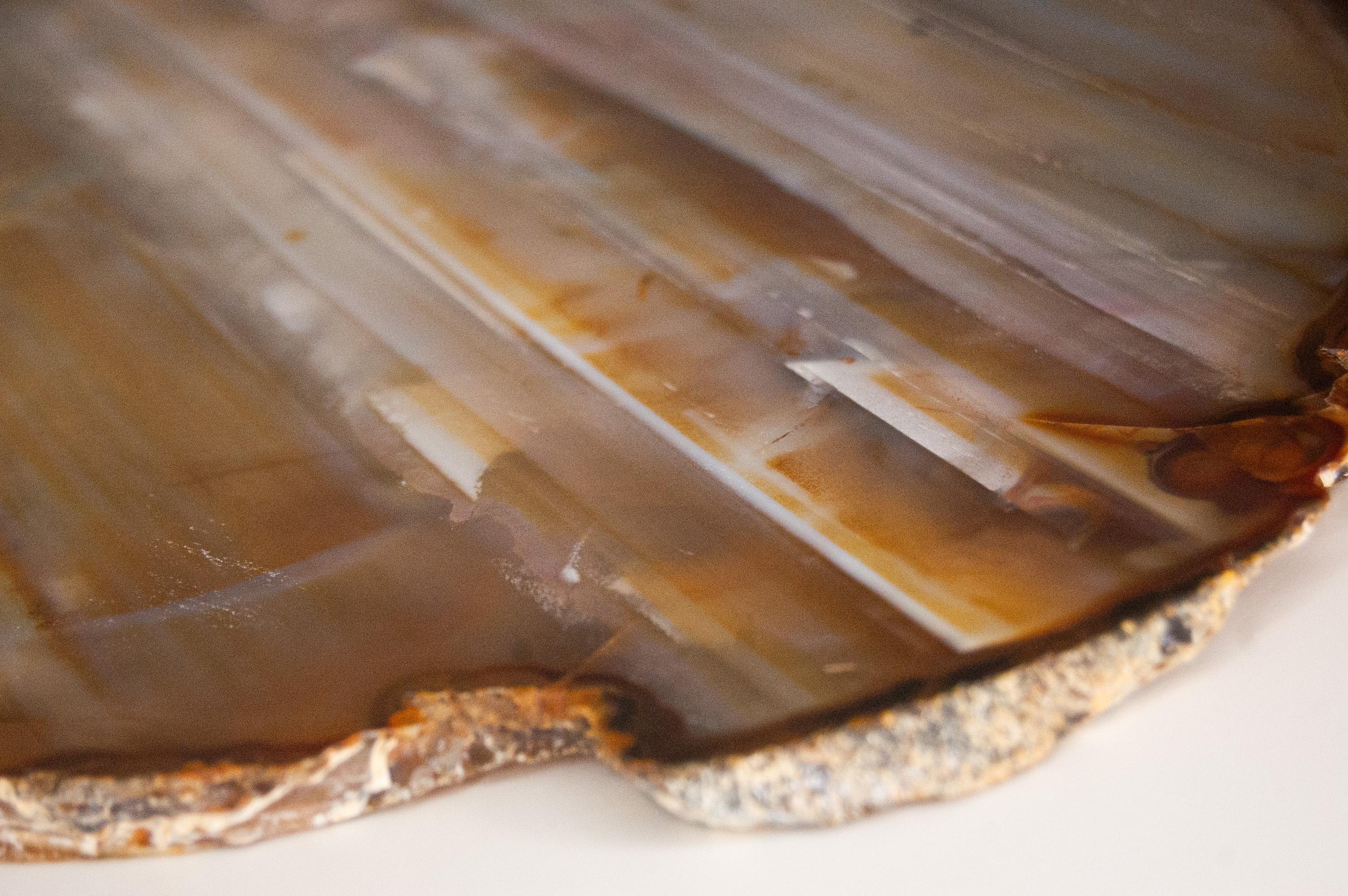 This one-of-a-kind natural agate serving tray is a luxury piece that brings the beauty of nature to any space. It stands out as a unique decorative piece and will impress guests at home as well as in a corporate event. Perfect gift for those who