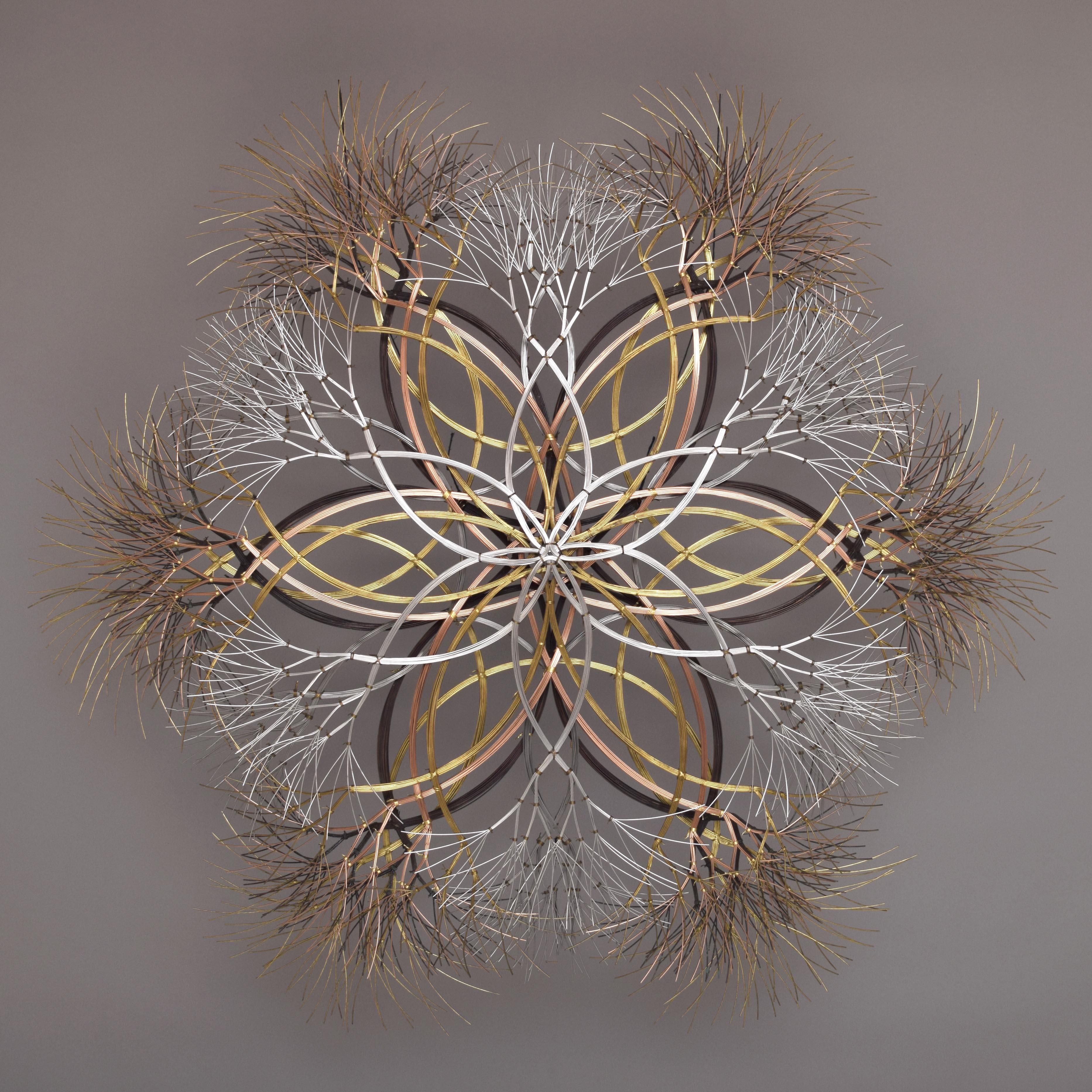 This snowflake sculpture is created using bronze, brass, and stainless steel wire. Kue uses an aesthetic reminiscent of trees, electricity, and light to create sculptures of peace and beauty. Adults and children alike see snowflakes, trees, flowers,