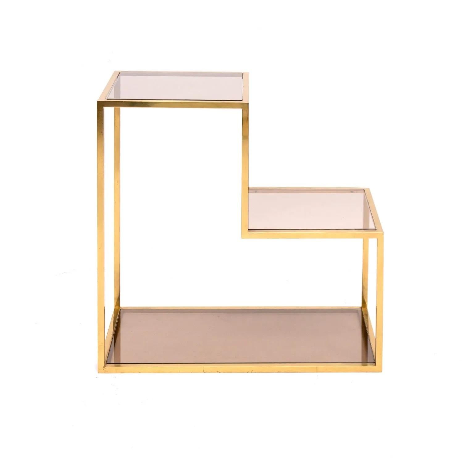 This vintage brass display cabinet features unique midcentury design, combining simple lines and an elegant way to store and display. In the style of the Italian designer Romeo Rega.