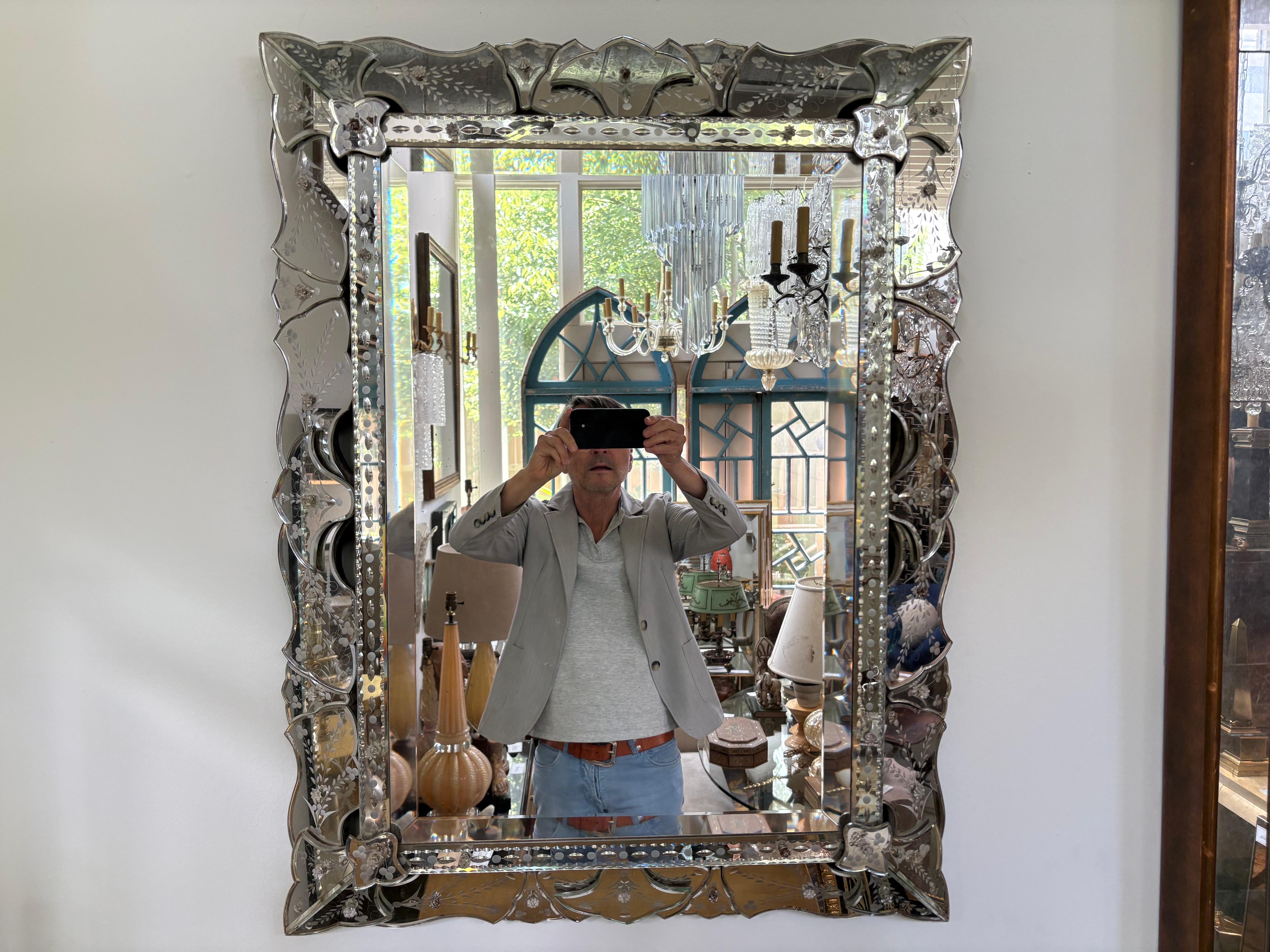 Etched And Beveled Venetian Mirror.
Offered is a lovely vintage beveled Venetian mirror with an interesting scalloped etched design of applied sections of mirror.
Our Venetian mirror, created in the 1940's can be displayed either vertically or