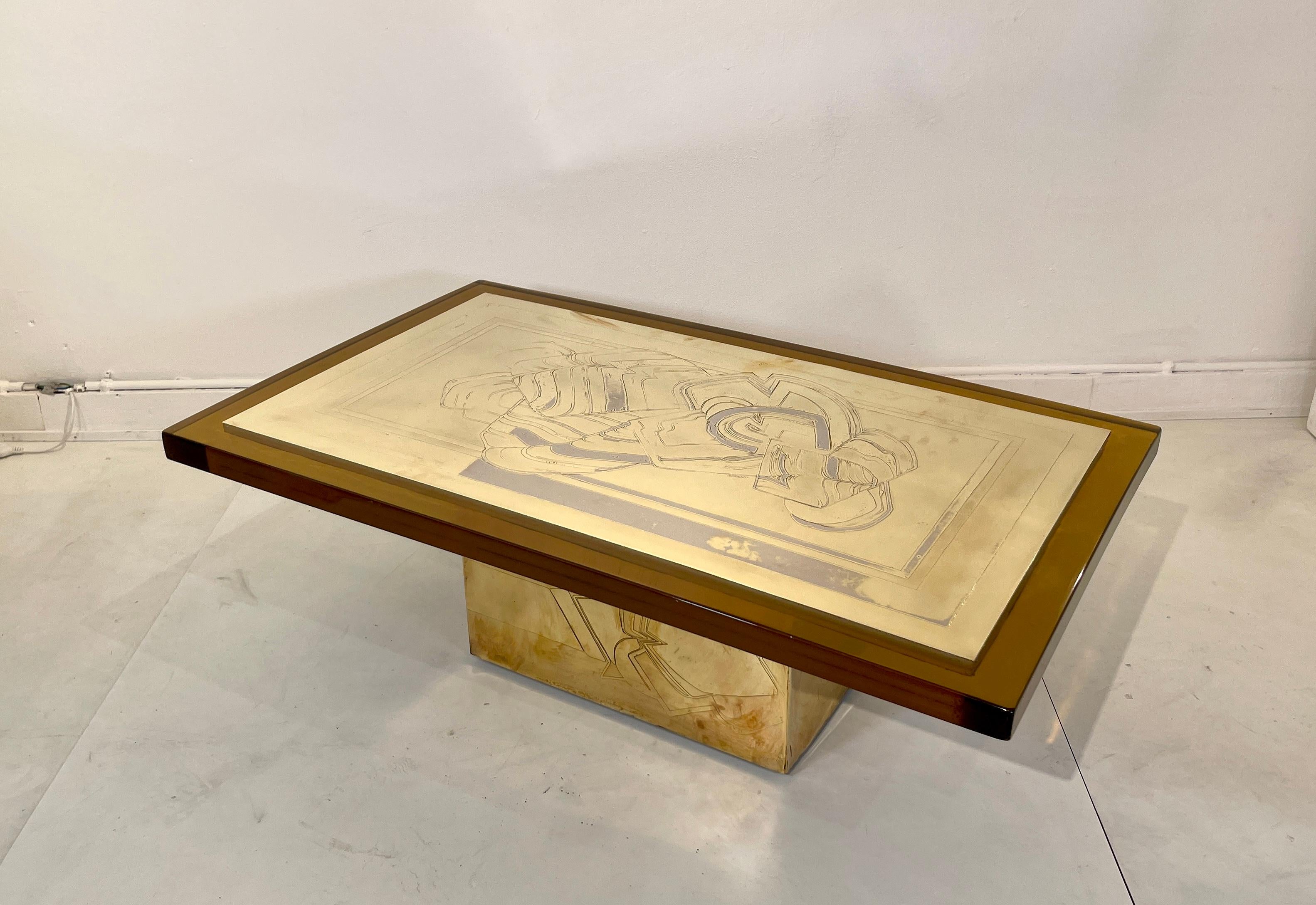 Rare and beautiful coffee table by Armand Jonckers. Etched brass (double patin (brass and silver) )  and resin in very good and original condition. the feet also has an acid-etched decor. Signed Armand.
