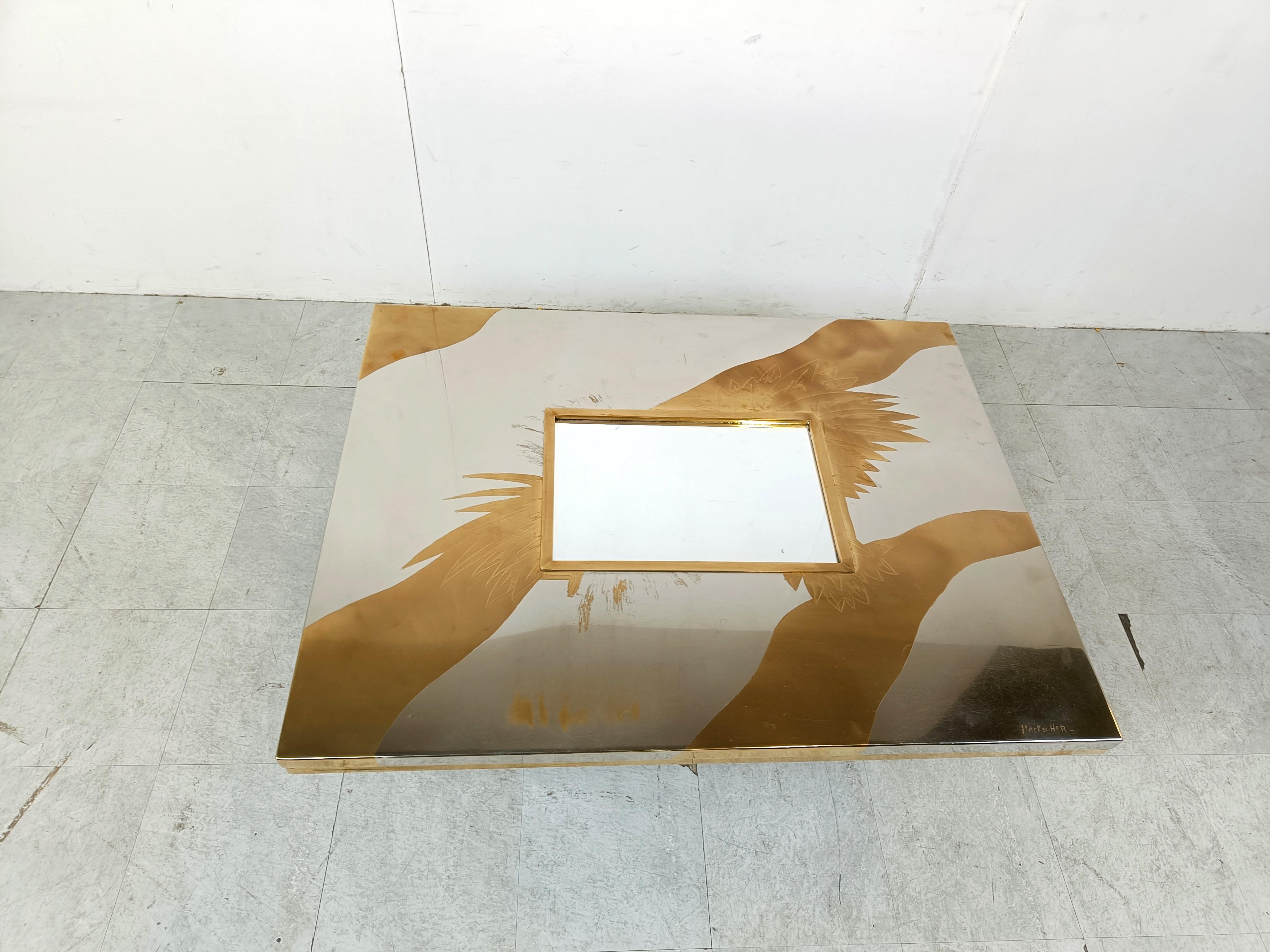 Very rare coffee table by Christian  Heckscher consisting of an etched brass and chrome table top with an inlaid mirrored glass.

Leaf engravings and organic waves of brass contrasting nicely with the chromed table top.

Black metal base.

Signed by