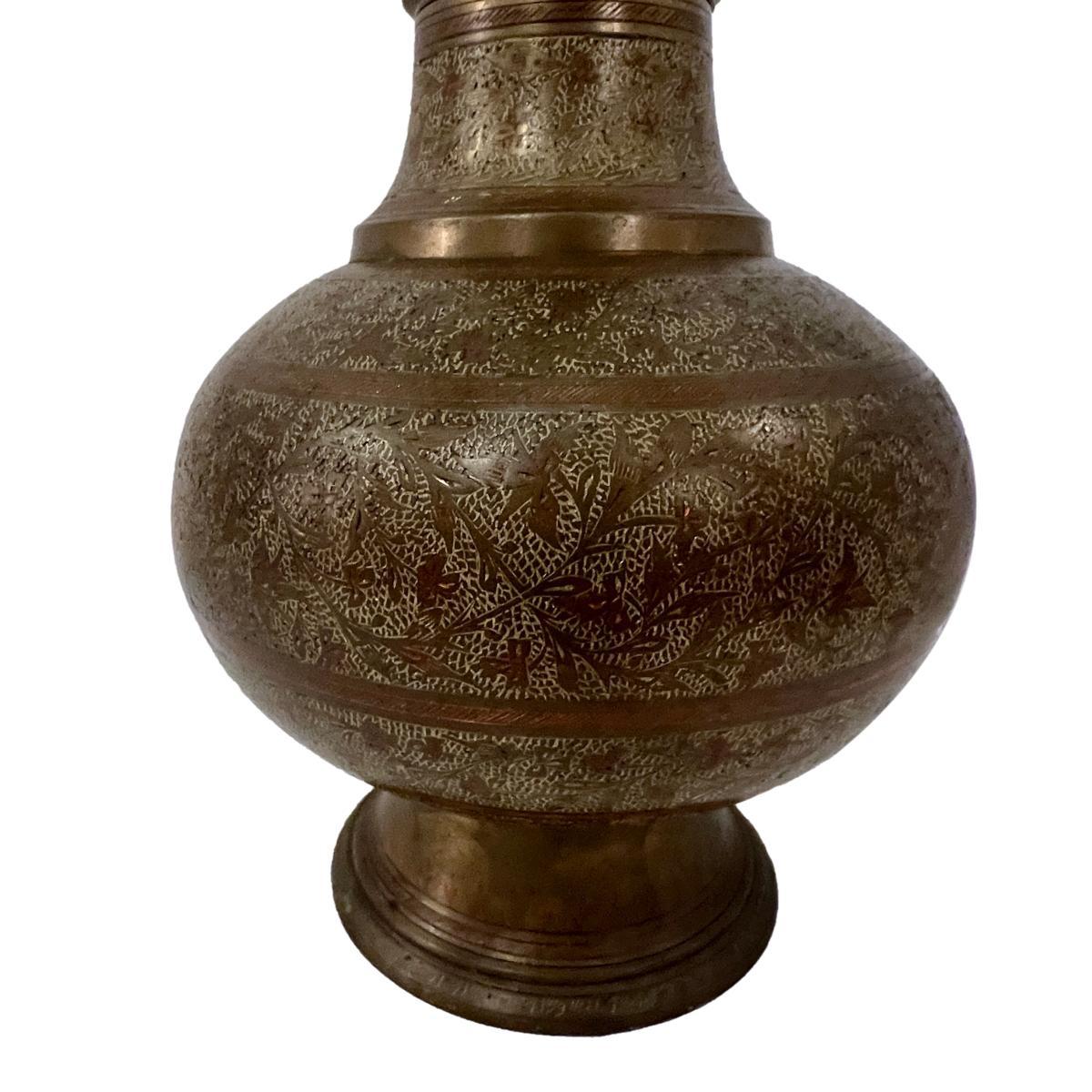 A circa 1940's Persian etched metal lamp with foliage motif.

Measurements:
Height of body: 20
