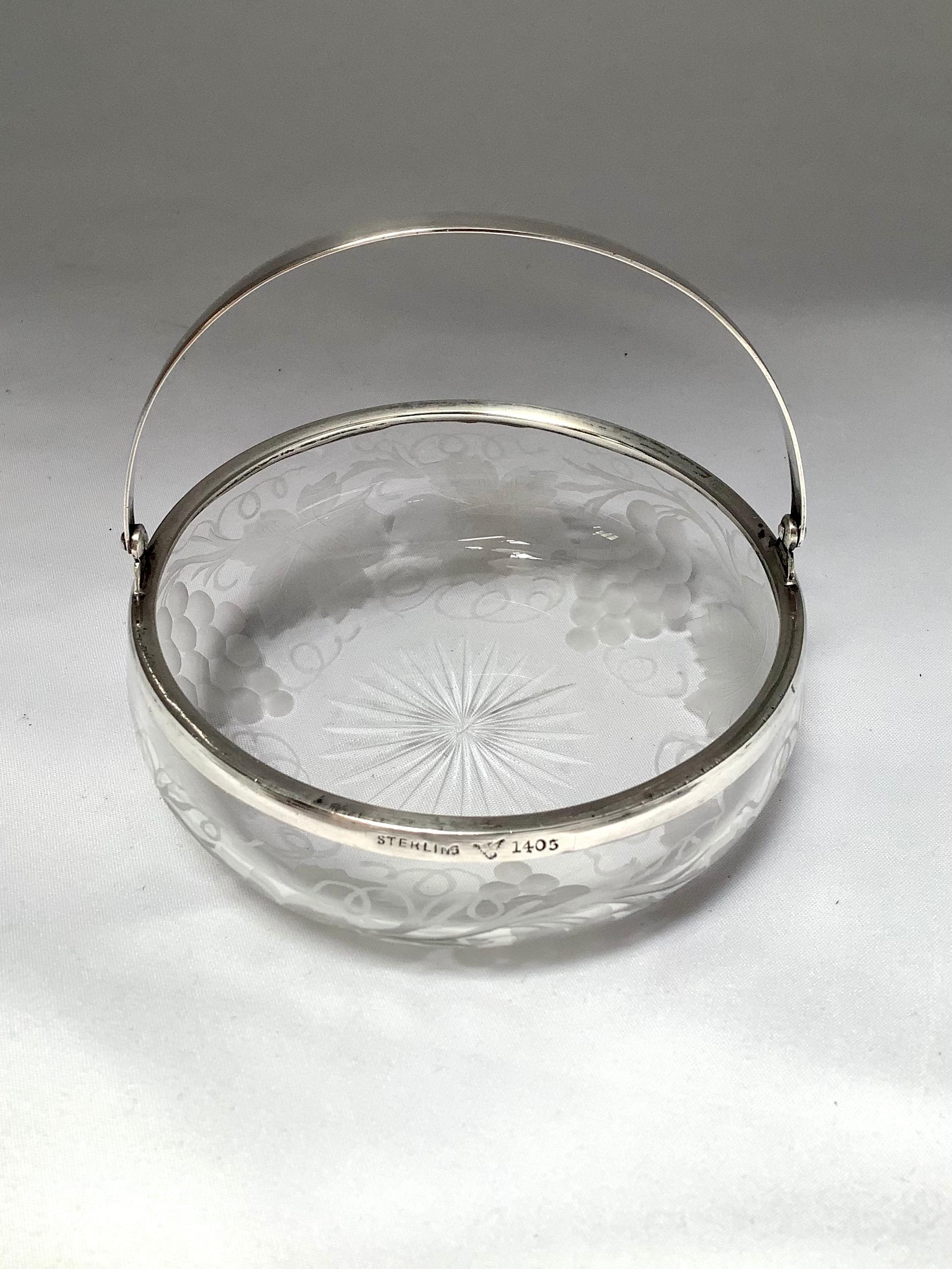 Crystal candy dish with beautiful etched grapevines throughout. The charming dish has a sterling silver handle that is clearly marked.
