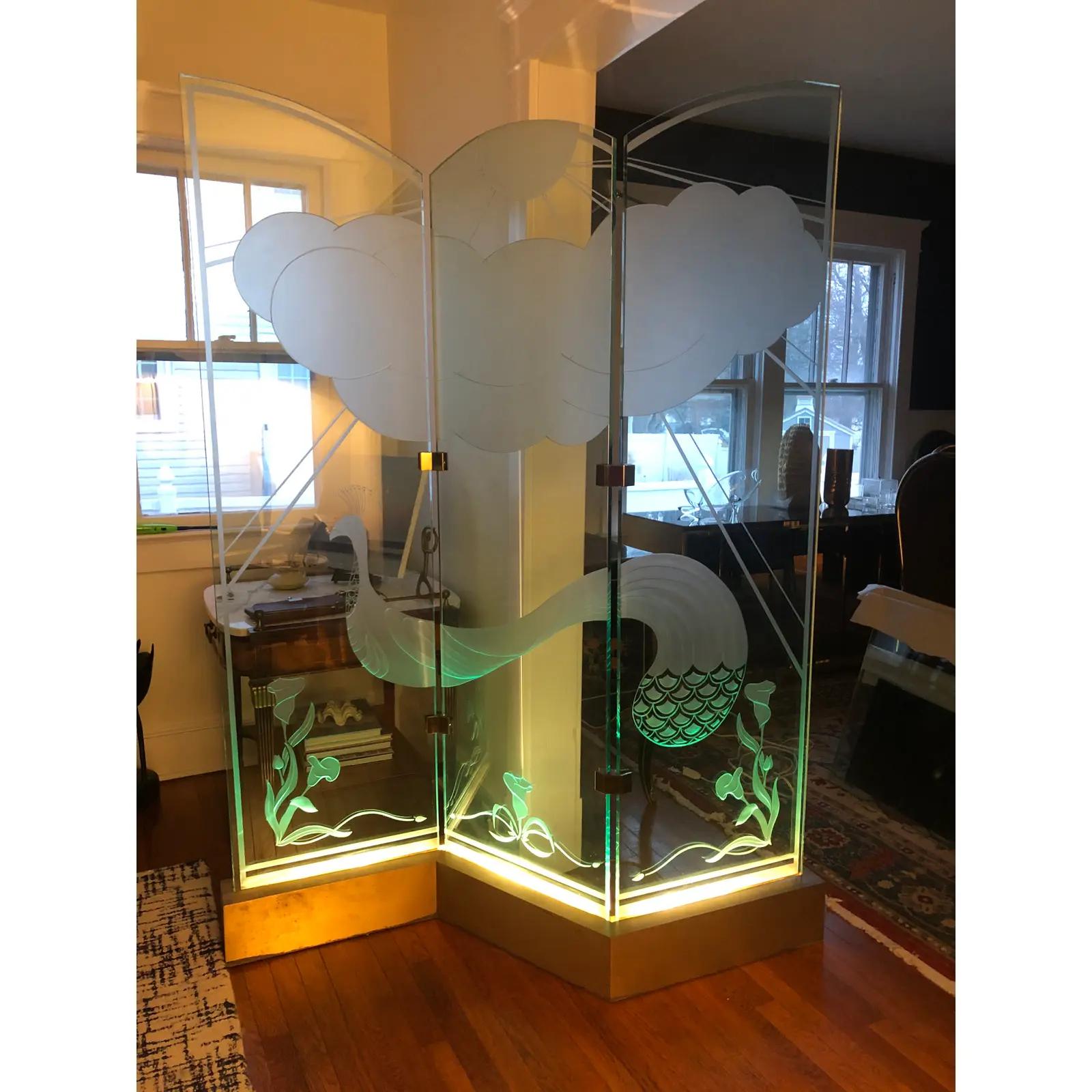 Wonderful RARE 3 panel room divider with deep etched glass. Peacock and Lillies with Sun, Rays and Clouds. All lit by channeled metal(brushed bronze) base with recessed lighting. Great visuals with asymmetrical arched top, 3/4” glass that lights to