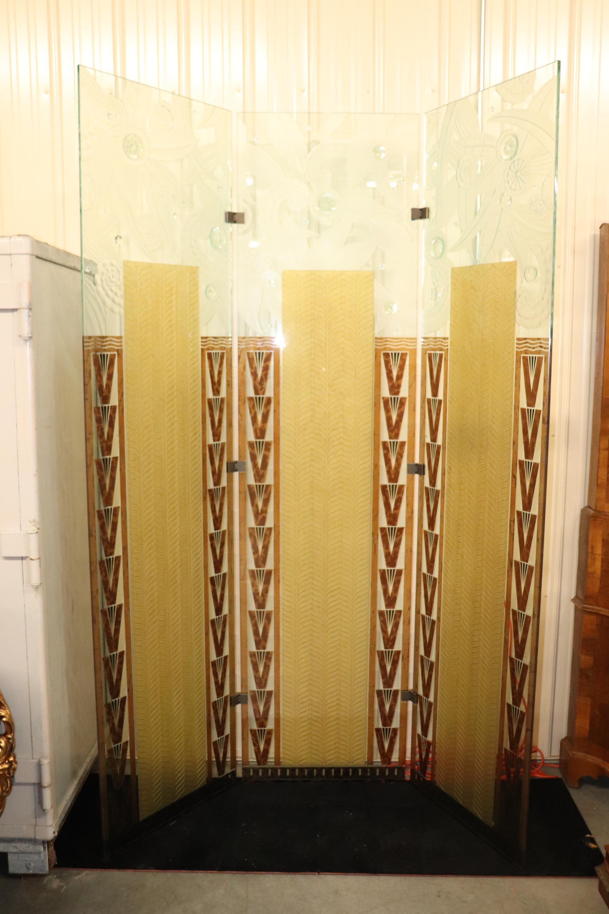 This is a superb skyscraper style French Art deco dressing screen. The screen is deeply etched in multiple depths and has a variety of themese ranging from waves to floral patterns and chevron shapes. The screen is in superb condition and seems to