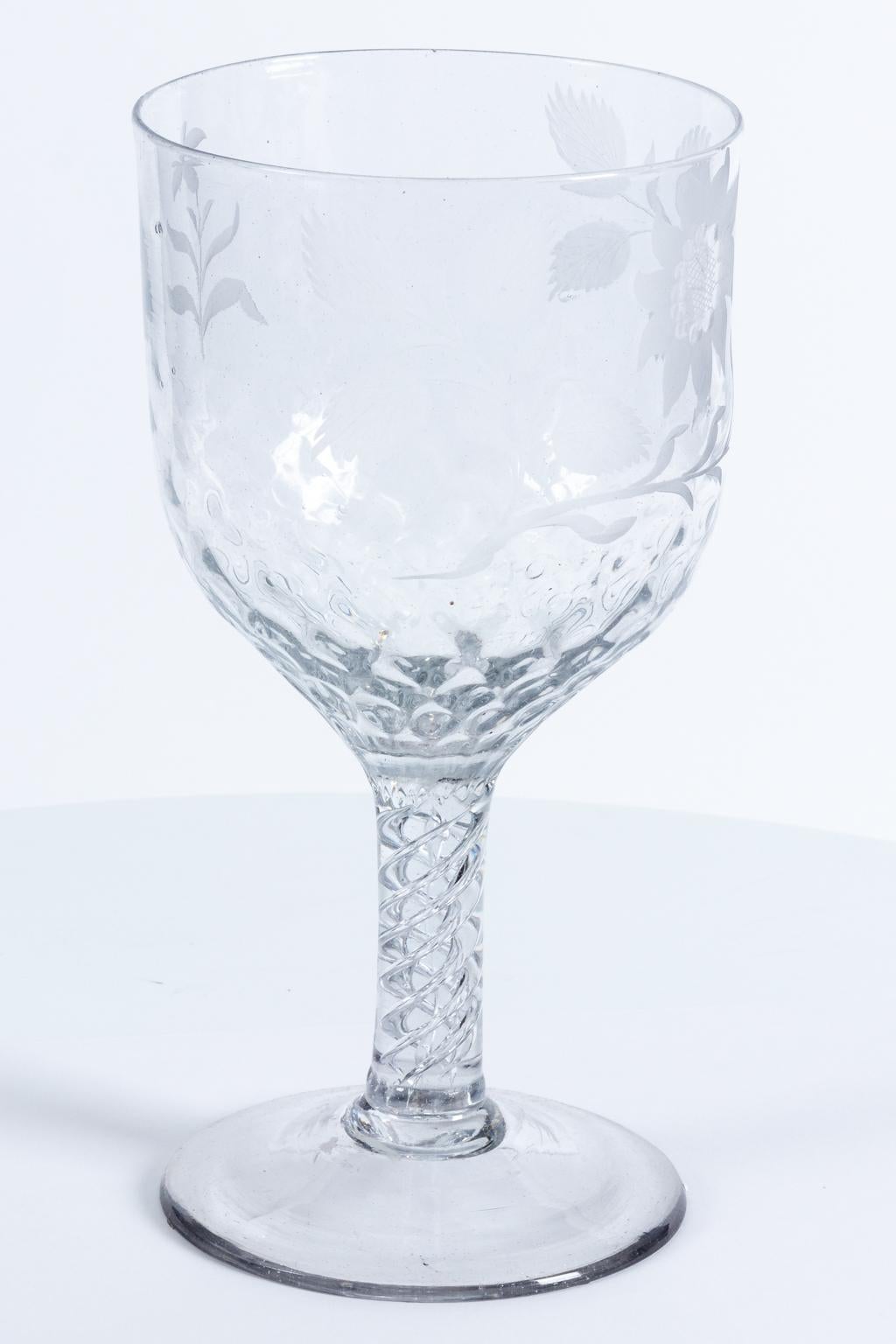 Etched glass goblet stemware with floral motifs. Please note of wear consistent with age.