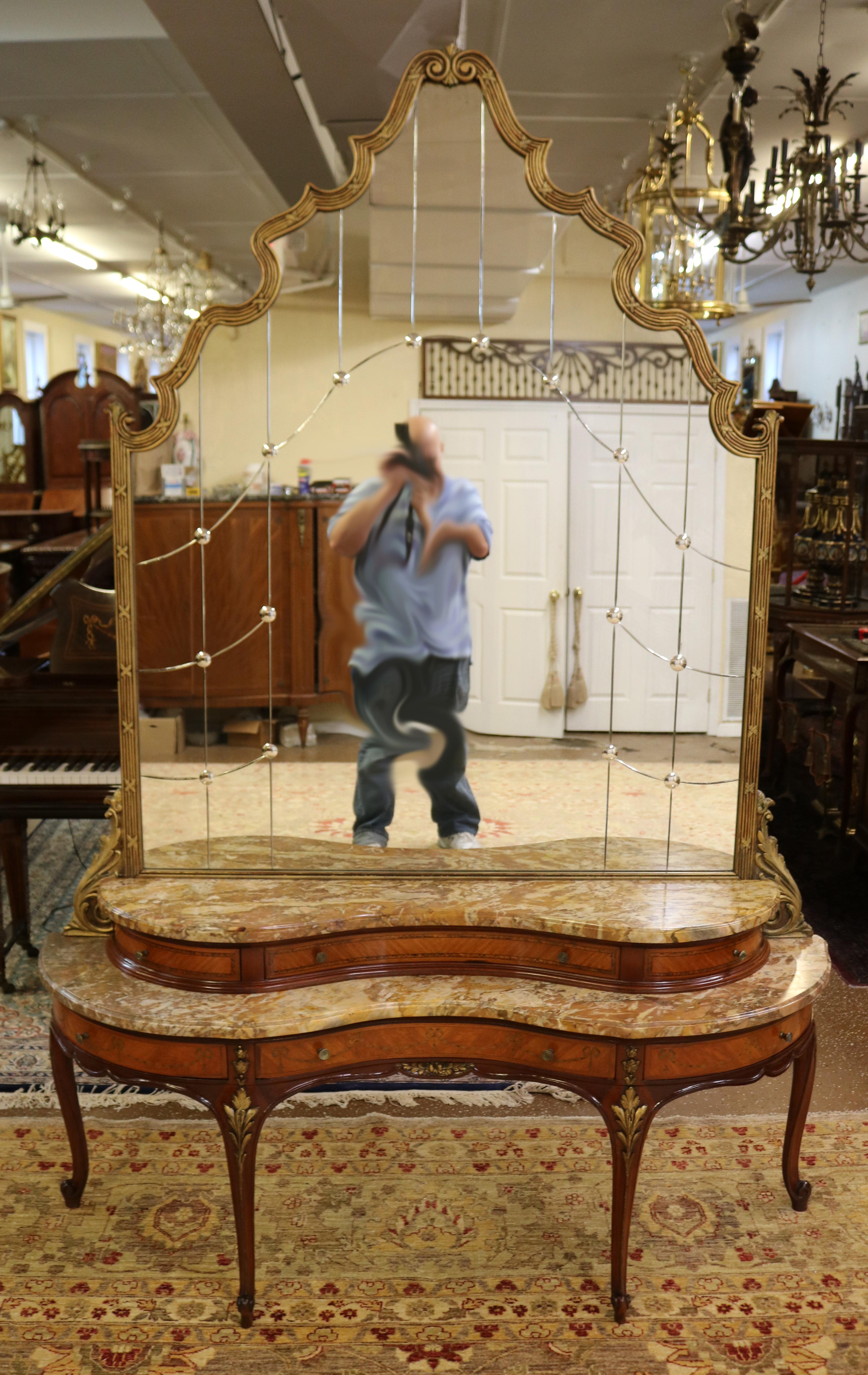 This stunning marble top vanity was made in France in the early 20th century and has a stunning etched gold mirror! The kingwood has stunning grain and the inlay is excellent!