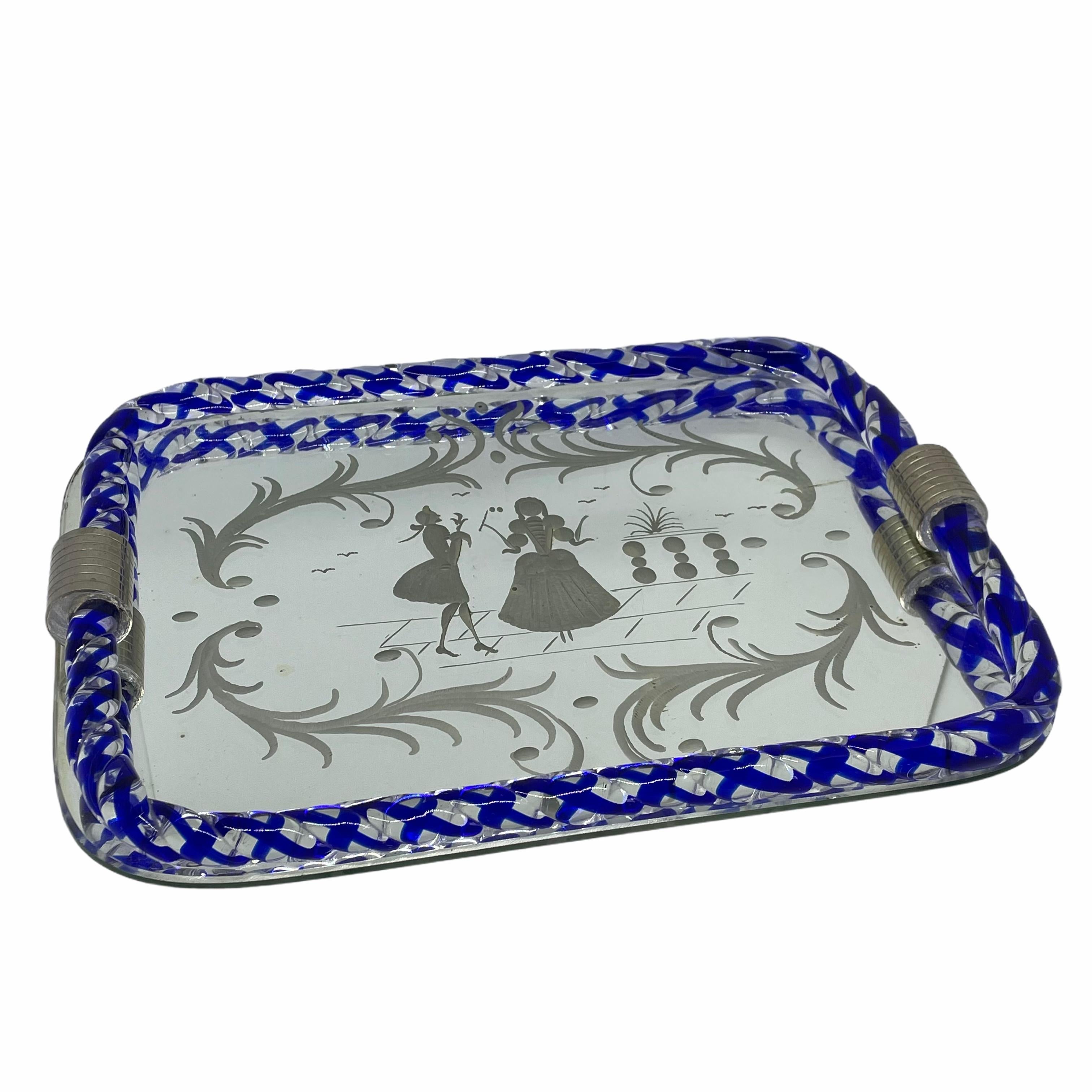 Created by Ercole Barovier, this piece is a beautiful Italian serving or vanity table tray edged in Murano glass rope that is embedded with blue. Done in the style of Luigi Brusotti and Gio Ponti, the mirror is etched with Venetian romantic figures
