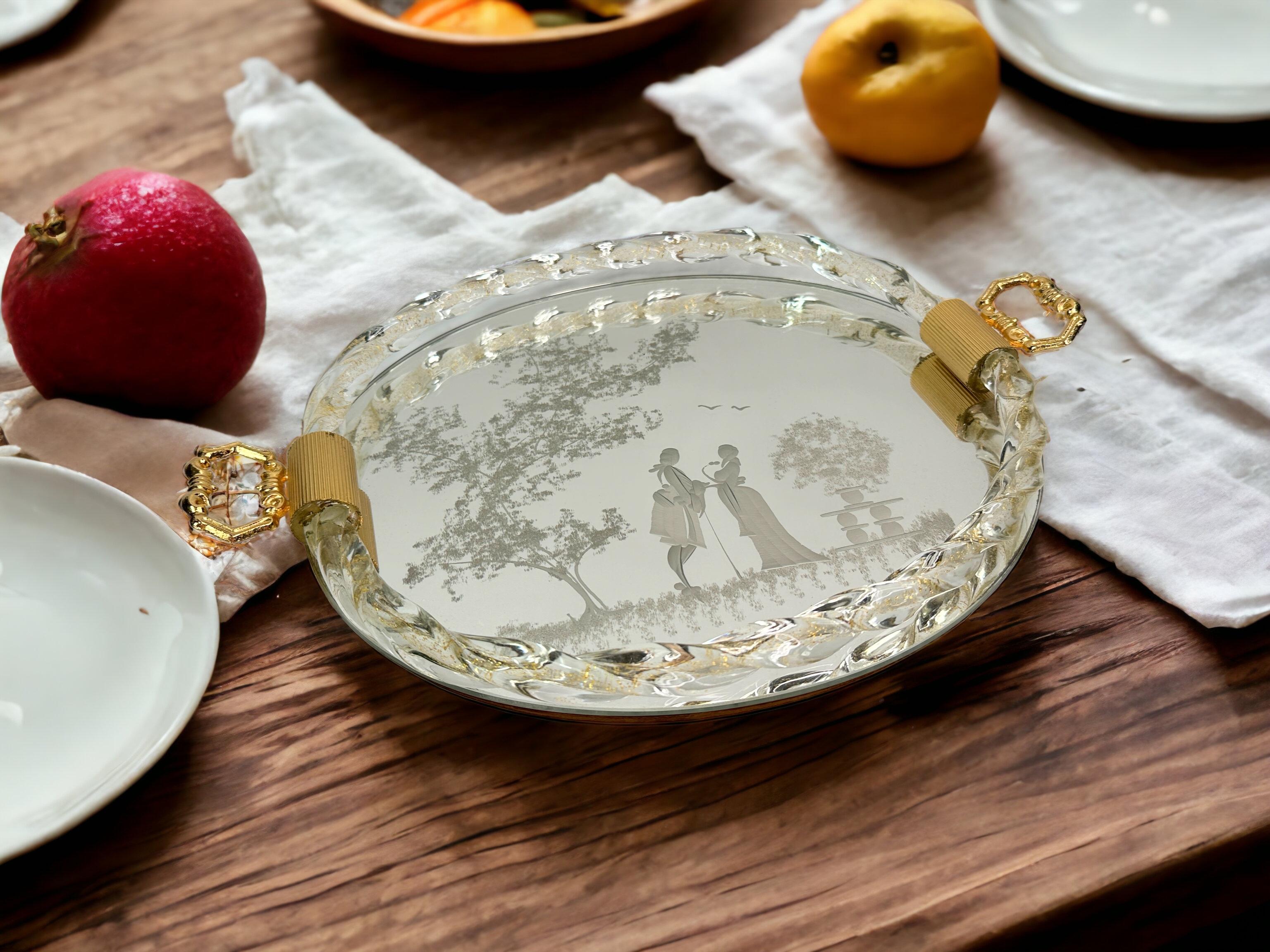 Created by Ercole Barovier, this piece is a beautiful Italian serving or vanity table tray edged in Murano glass rope that is embedded with clear gold flakes. Done in the style of Luigi Brusotti and Gio Ponti, the mirror is etched with Venetian