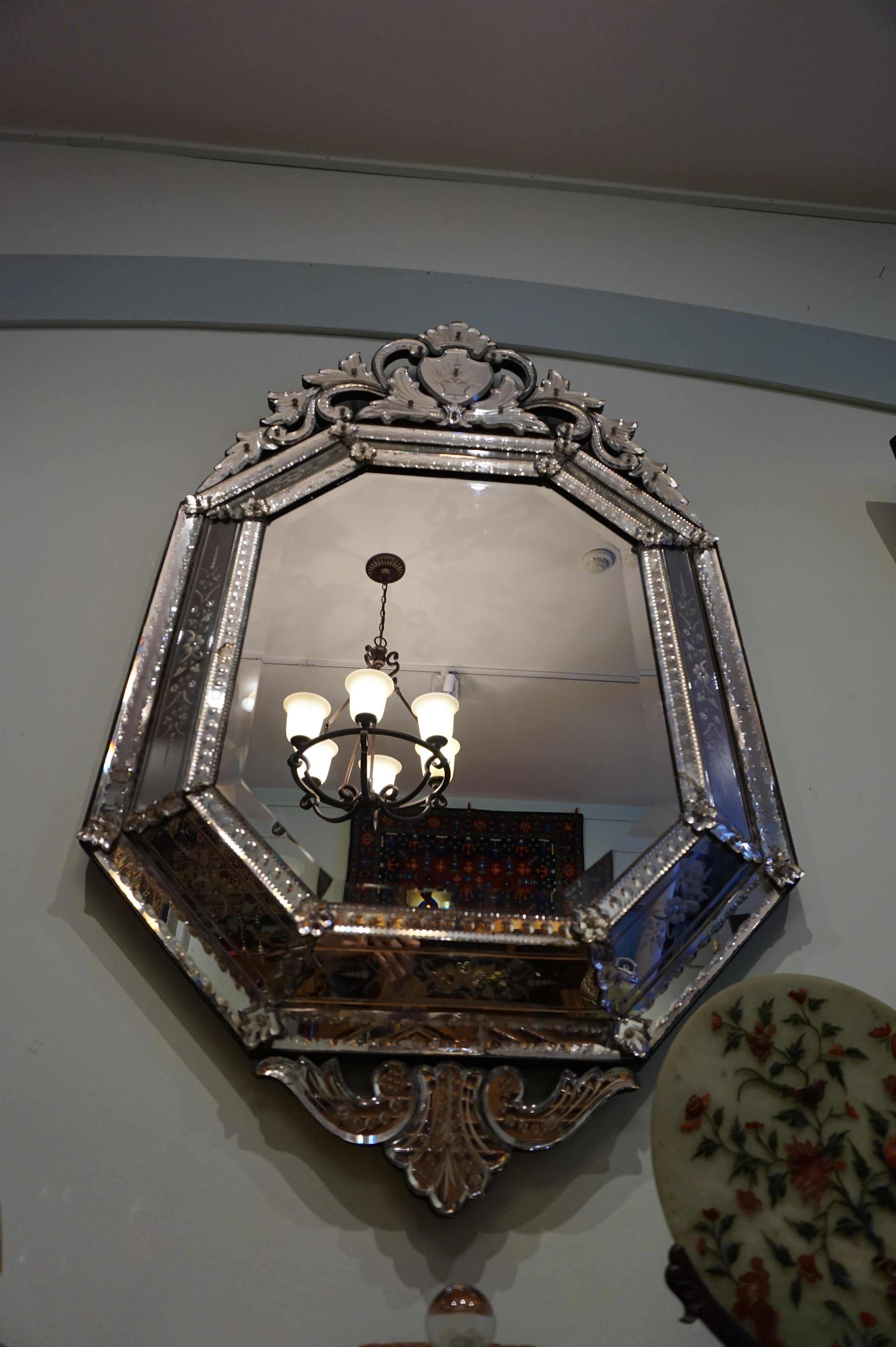 Cut Victorian mirror glass within a floral cut frame with beautiful etchings. Mounted with a scrolling crest echoed at base. Single mirrored pin cushion absent yet overall condition intact despite minor lead patination. Shows well,
circa
