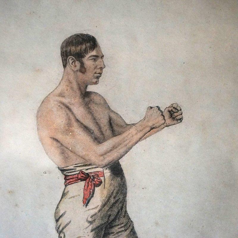 Antique Framed Pugilism Print, Early 19th Century
 
Hand-coloured etching depicting Martin with his sideburns, breeches and well-built physique putting up his dukes.
 
Underneath there are five lines of fighting history charting his career to this