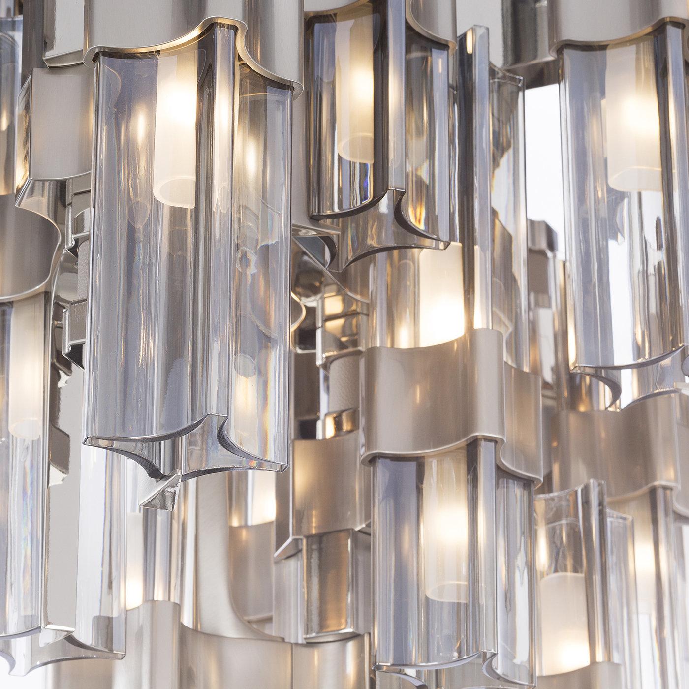 This pendant light gives off a futuristic vibe and will be a stunner when hung up in any room. Part of the Eterea collection, it hangs from a metal chain and has unique geometric lines and irregularly placed smoke-gray crystal shades that diffuse