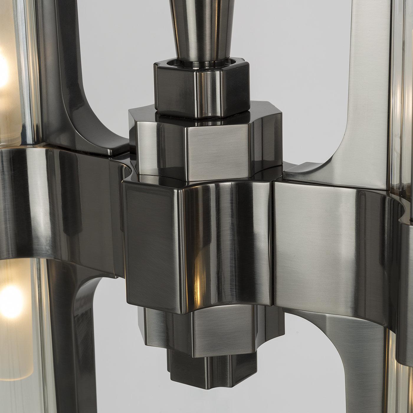 Make a statement with this modern pendant light fixture, part of the Eterea collection. The fixture is in a metal structure with a black nickel finish that holds two transparent crystal shades with metal accents. This piece's particularity is that