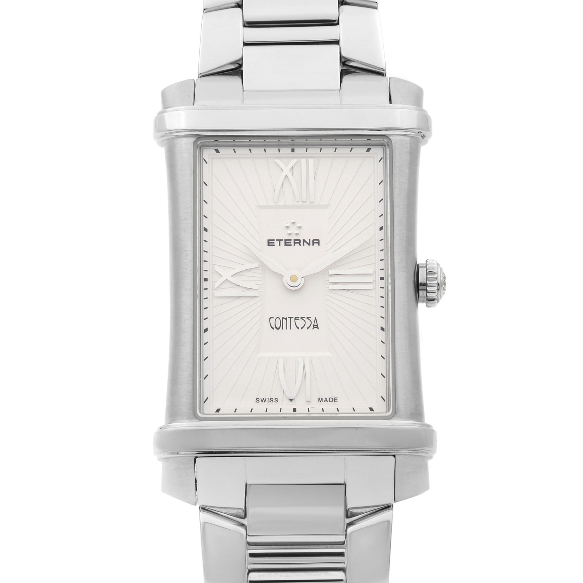 This display model Eterna Contessa  2410.41.65.0264 is a beautiful Ladie's timepiece that is powered by quartz (battery) movement which is cased in a stainless steel case. It has a  rectangle shape face, no features dial and has hand roman numerals
