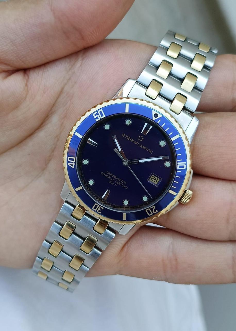 Brand : Eterna Matic

Model: Kontiki Chronometer

Country Of Manufacture: Switzerland

Movement: Automatic

Case Material: Gold & Steel

Measurements :40mm diameter (excluding crown )

Band Type : Stainless Steel . Gold With Marked Buckle

Band
