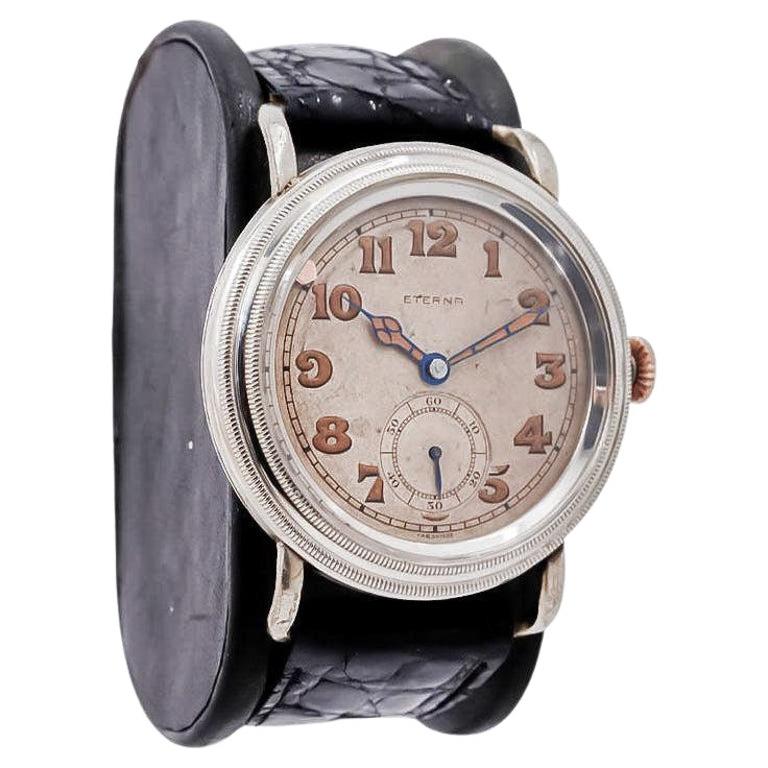 FACTORY / HOUSE: Eterna Watch Company
STYLE / REFERENCE: Campaign / Trench Watch 
METAL / MATERIAL: Nickel Silver 
CIRCA / YEAR: 1915
DIMENSIONS / SIZE:  Length 49mm X Diameter 42mm
MOVEMENT / CALIBER: Manual Winding / 15 Jewels 
DIAL / HANDS:
