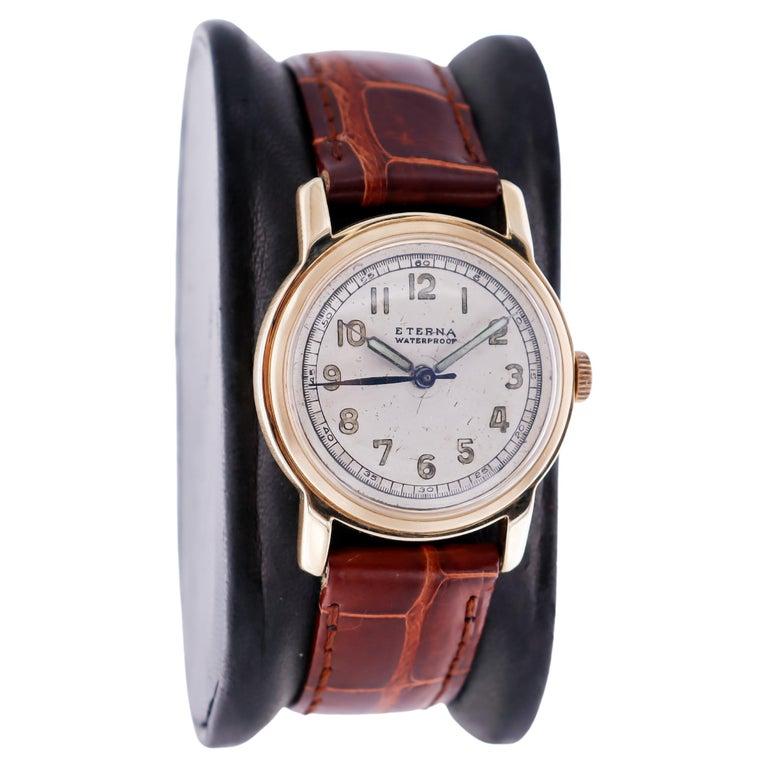 FACTORY / HOUSE: Eterna Watch Company
STYLE / REFERENCE: Round / Art Deco
METAL / MATERIAL: 14Kt. Solid Gold
CIRCA: 1940's
DIMENSIONS: Length 35mm X Diameter 29mm
MOVEMENT / CALIBER: Manual Winding / 17 Jewels 
DIAL / HANDS: Original Patinated