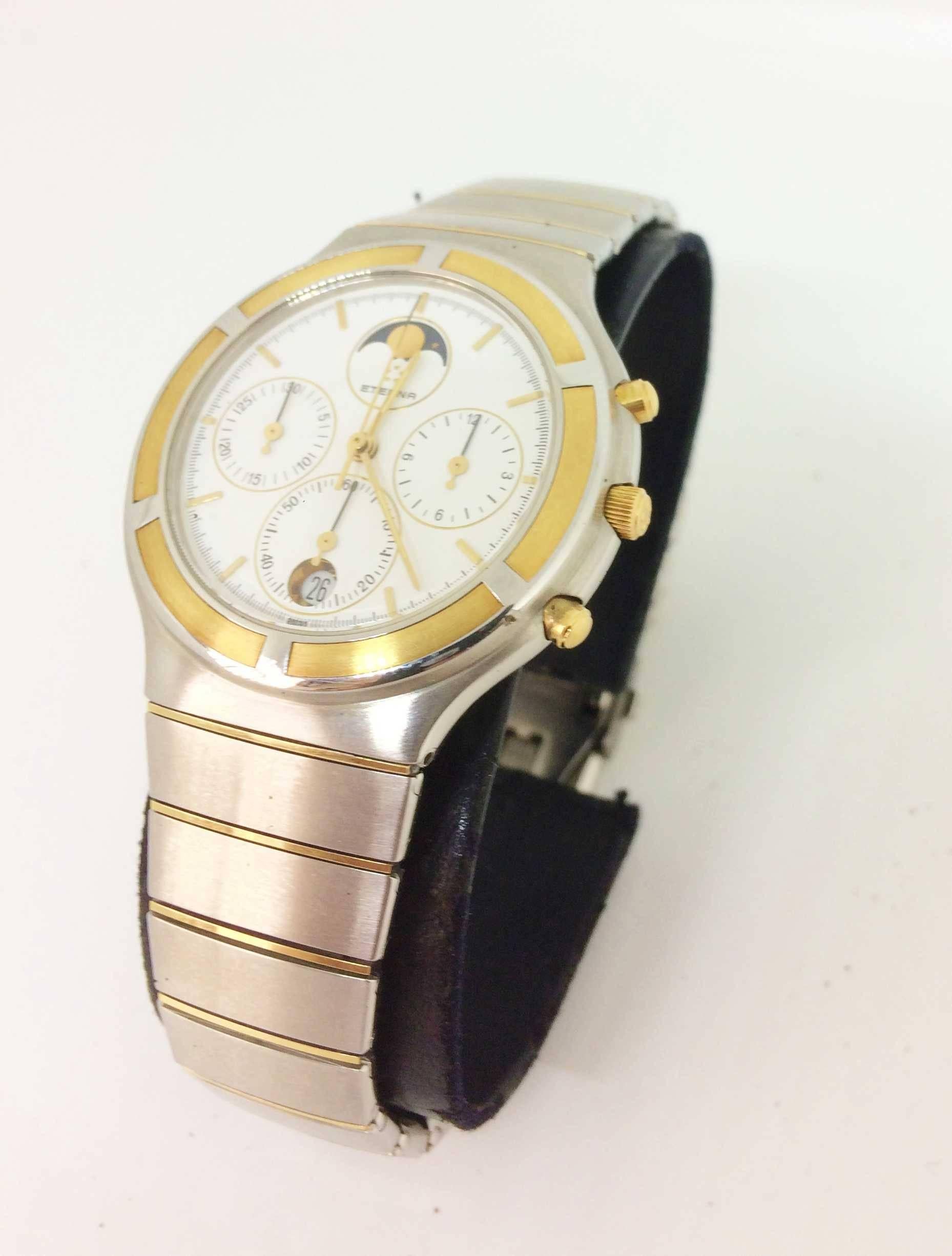 Gold and Steel
Gold and Steel Bracelet 

White Dial 
Gold and Steel Bezel 
3 counters
Date at 6 o'clock

Moon Phase

High resolution quartz

New battery
New stock

New value: € 2,800
Selling price: 690 €

1 year warranty